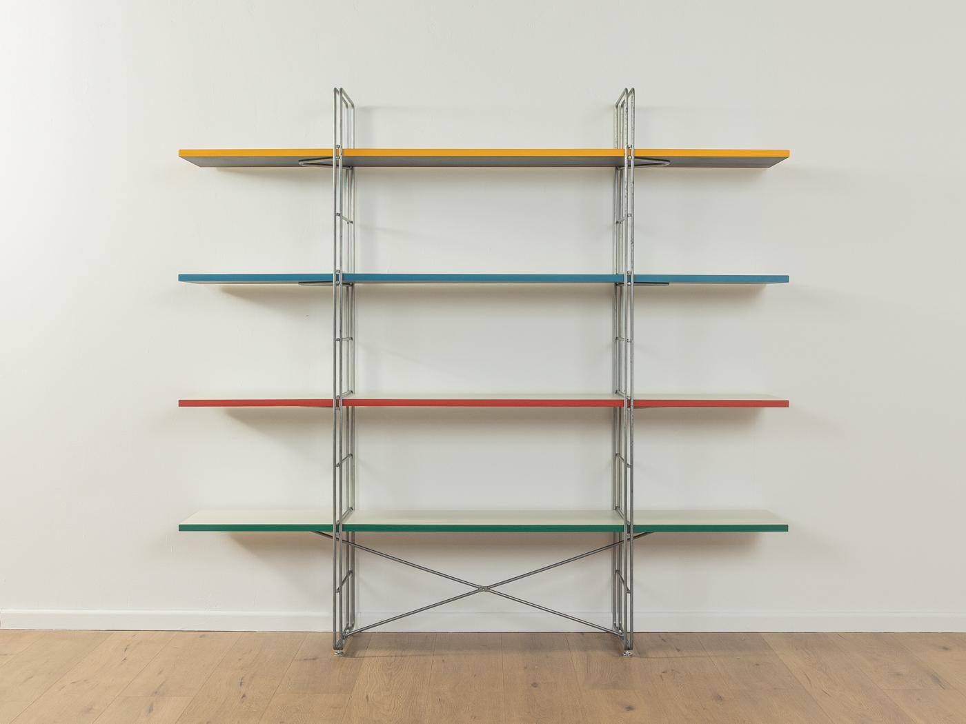 Original GUIDE shelf by Niels Gammelgaard for IKEA from the 1980s. Powder-coated metal frame in matt grey with four chipboard shelves in white with colored edges.

Quality Features:

    good workmanship
    high quality materials
    Made in