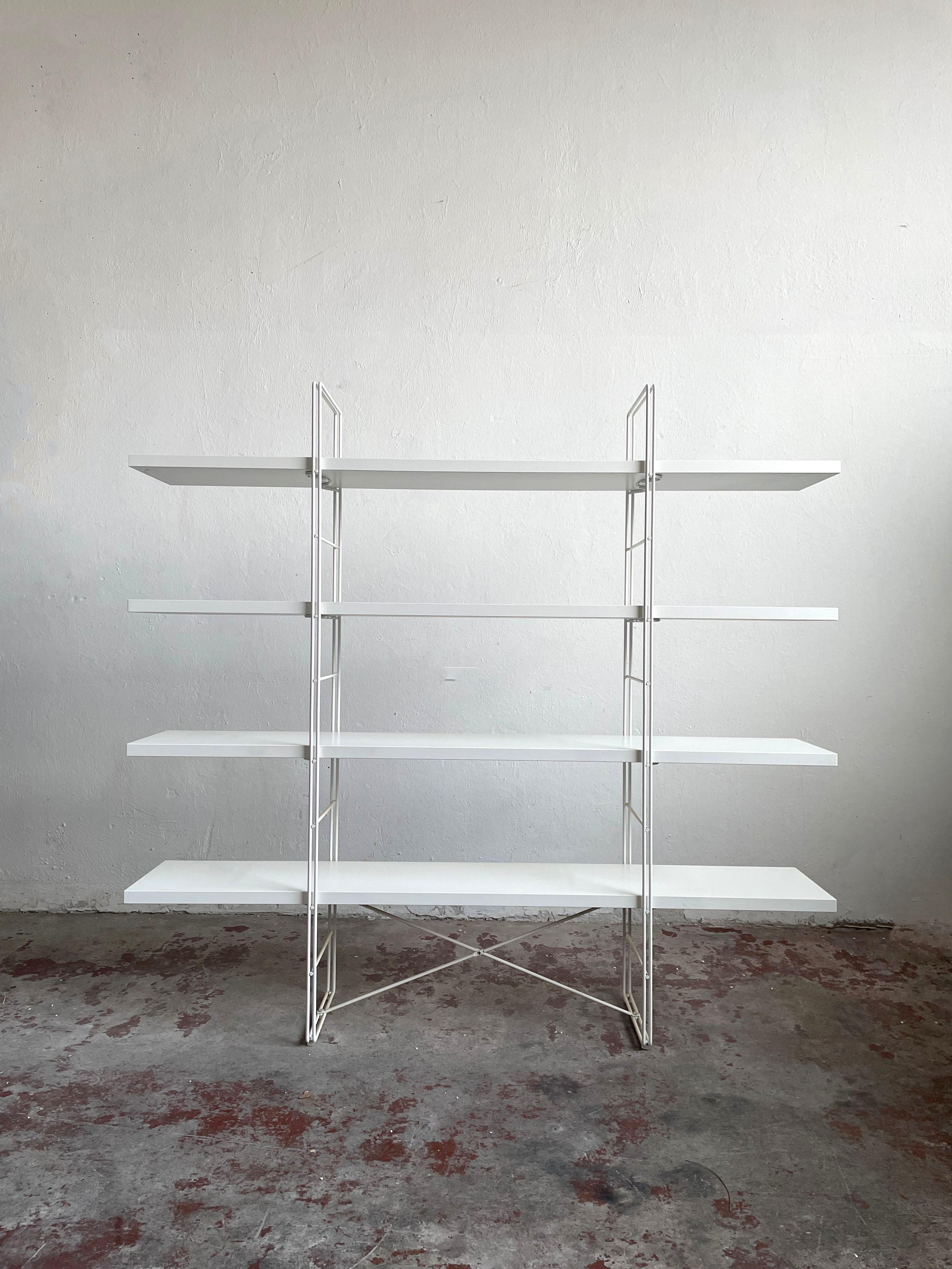 “Guide” Shelving Unit is a modern design classic designed by Niels Gammelgaard for IKEA in 1985.

The sturdy minimalist structure is made of powder-coated steel in white color. It has four minimalist white shelves made of laminated chipboard.