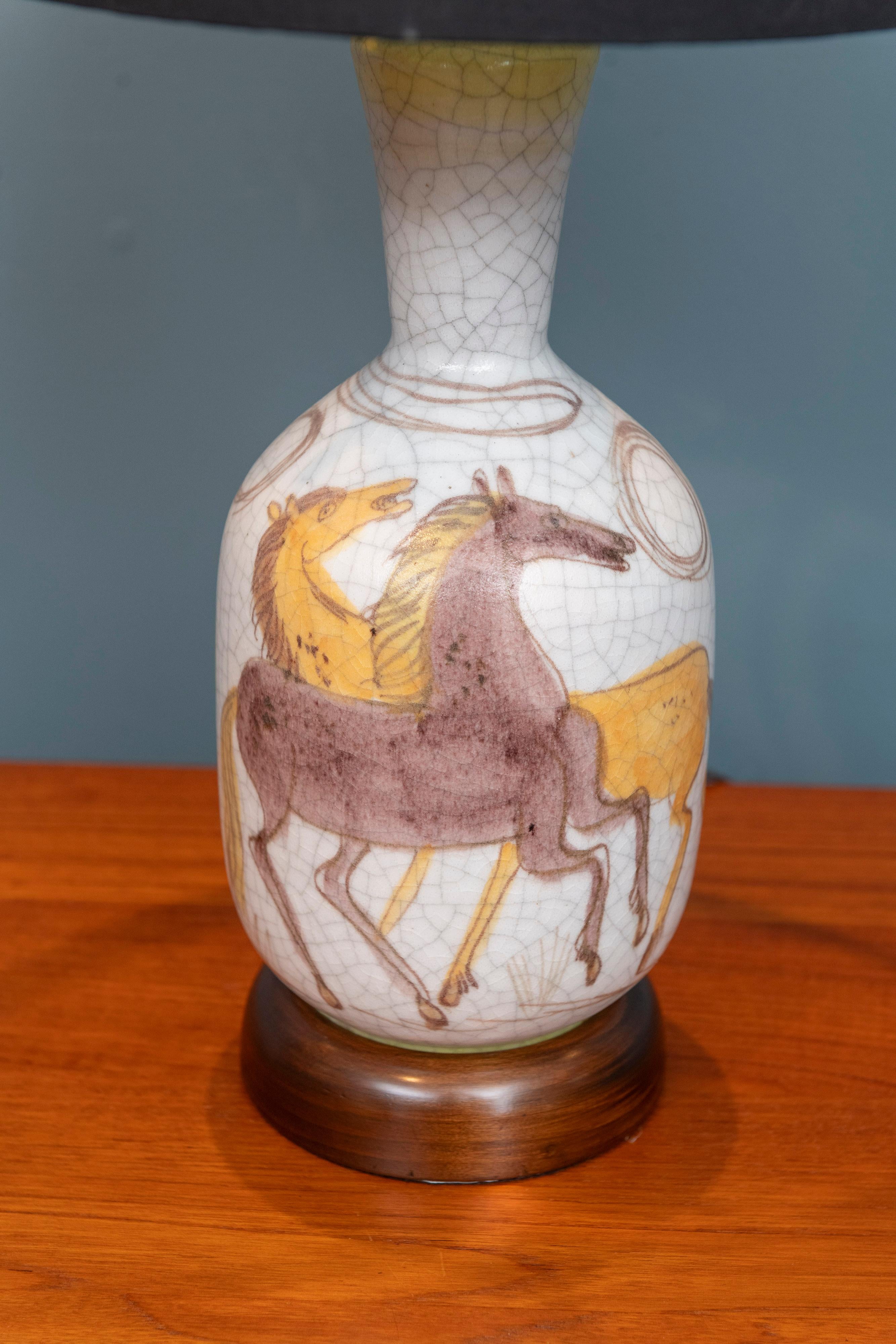 Guido Gambone designed cloisonné stoneware table lamp, Italy. Elegant decorative lamp with prancing horses encircling the body of the lamp. Signed Gambone Italy with the donkey stamp to the base. 
Refinished original wood base and just newly rewired.