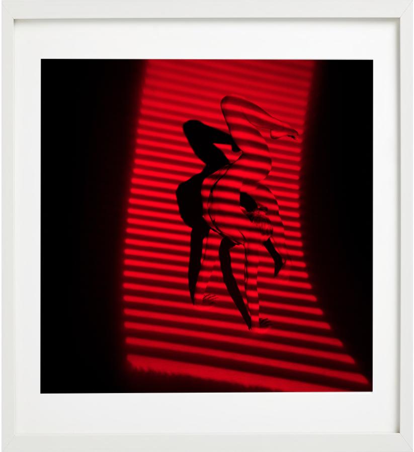 Giulia and Red Stripes - nude photograph of female model with red background - Contemporary Photograph by Guido Argentini