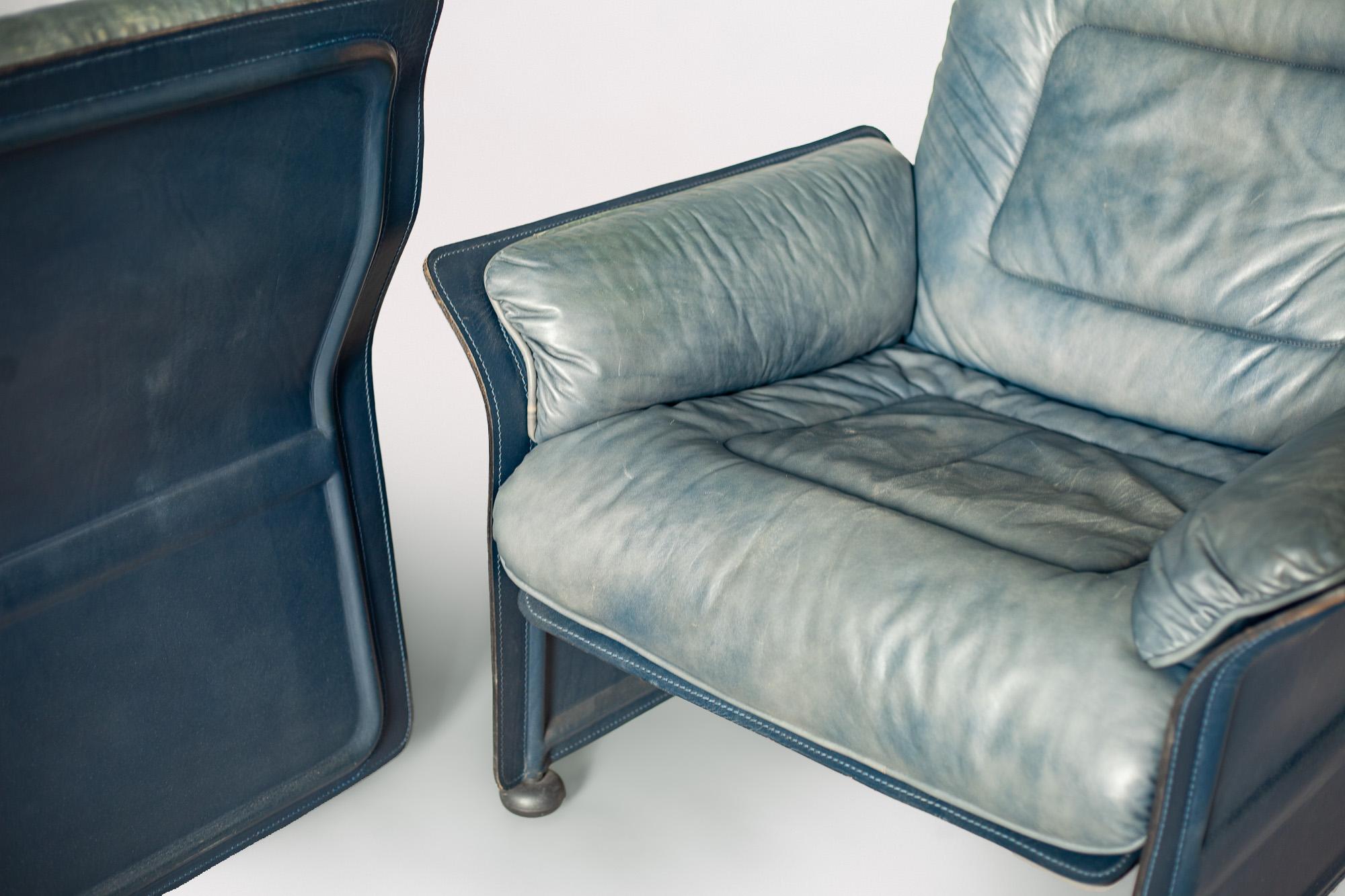 Blue leather club chairs designed by architect Guido Faleschini for i4 Mariani's Meteora collection, designed in the 1980s. Blue leather upholstered cushions on a saddle leather base. Made in Italy.