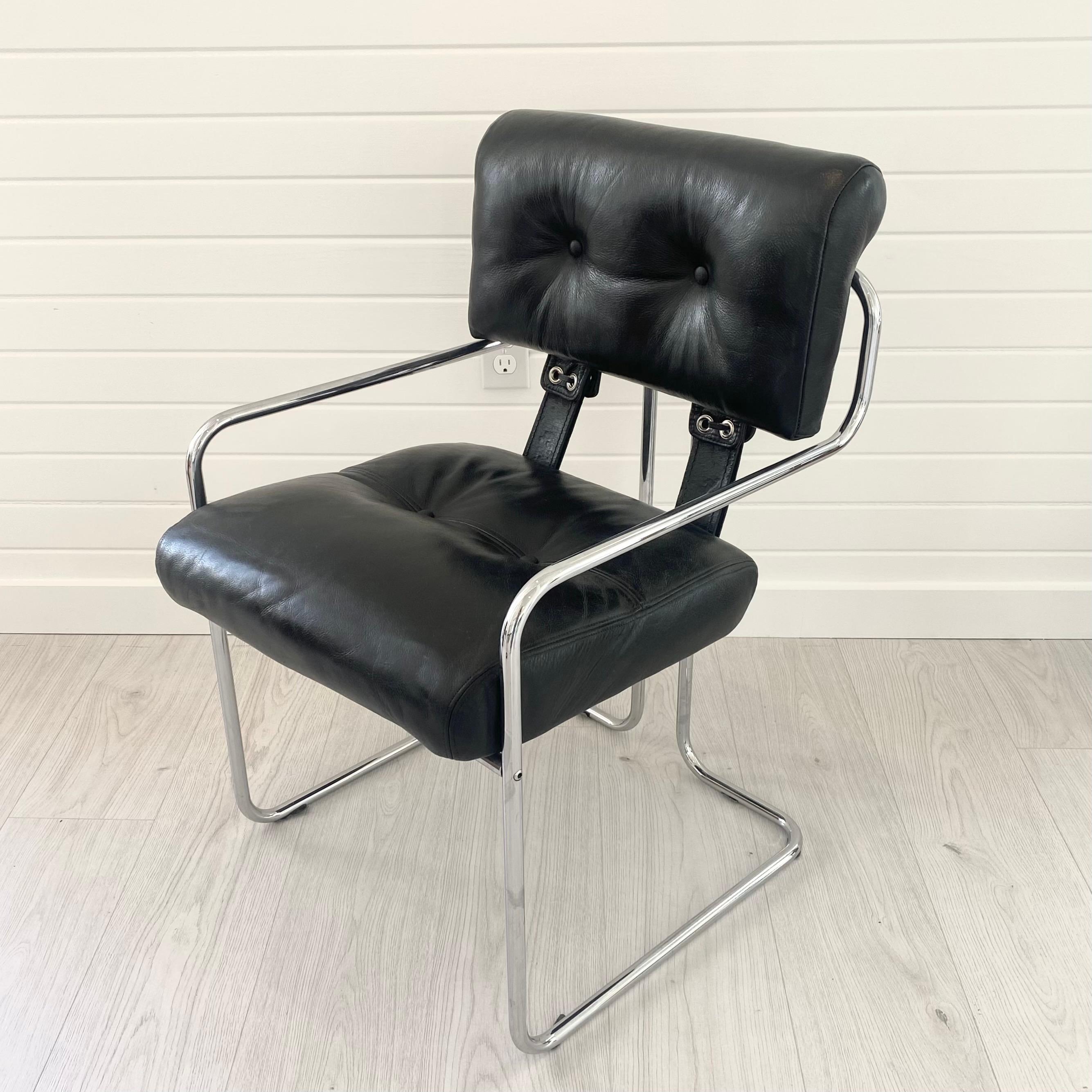 Handsome Tucroma chair designed by Guido Faleschini for Mariani, Pace. Sleek, original leather in black with the iconic chrome tube frame. Eyelets with leather strap closures secure the cushions to each other and to the frame. Great as a desk or