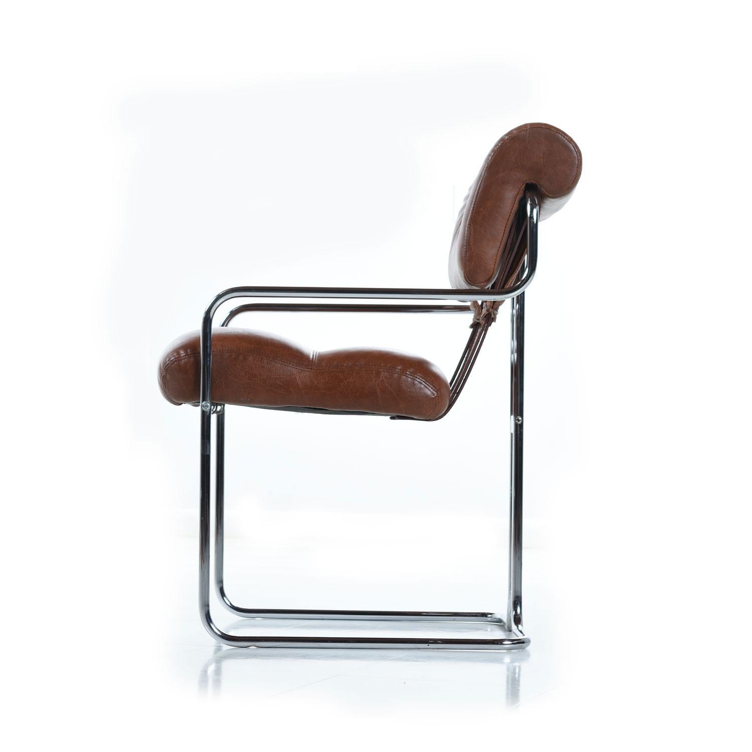 A set of Tucroma dining chairs designed by Guido Faleschini in 1972 and produced in Italy by Mariani for Leon Rosen's Pace collection. Polished tubular chrome frames with a mix of original leather straps and newer commercial vinyl. The rich, caramel