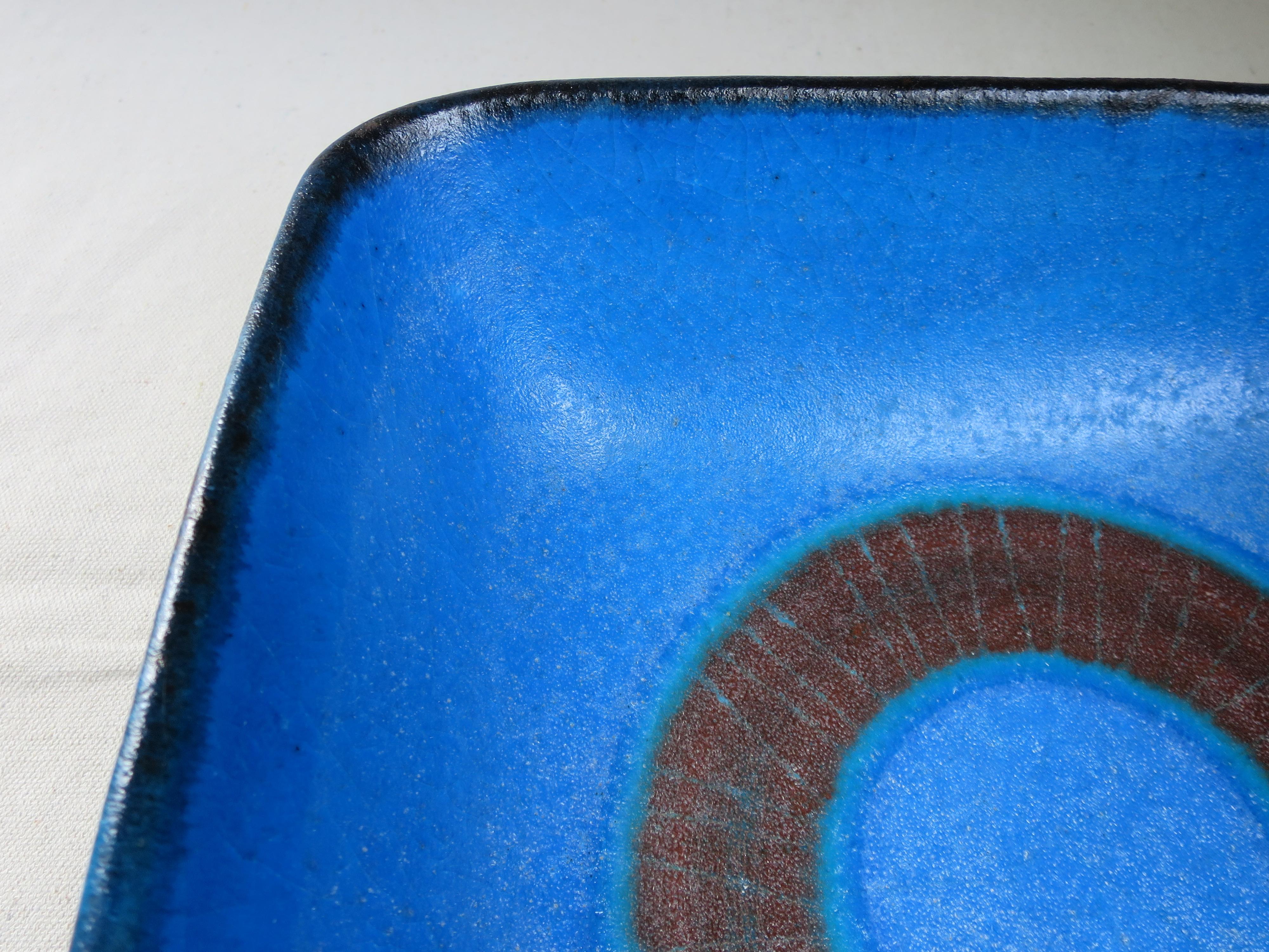 Stunning color and design!
A rich cobalt blue, with brown circle in center of bowl.
Generous square shape. Good presence.