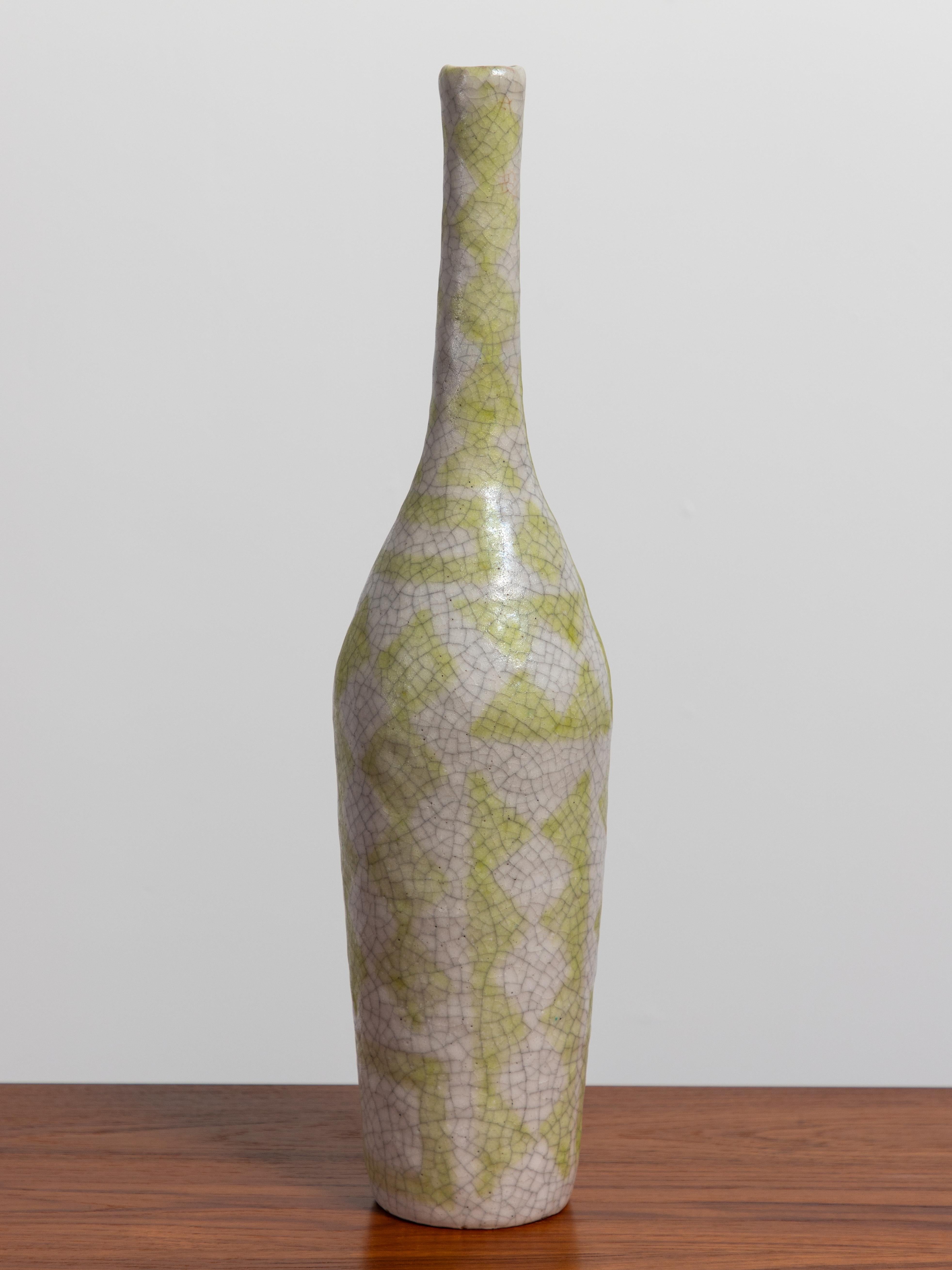 Stunning expressionist bottle vase by Guido Gambone. Vase is decorated with a vibrant geometric pattern all over, in a striking citron yellow that pops against a white background. The craqueleure finish on the glazed stoneware enhances the rustic