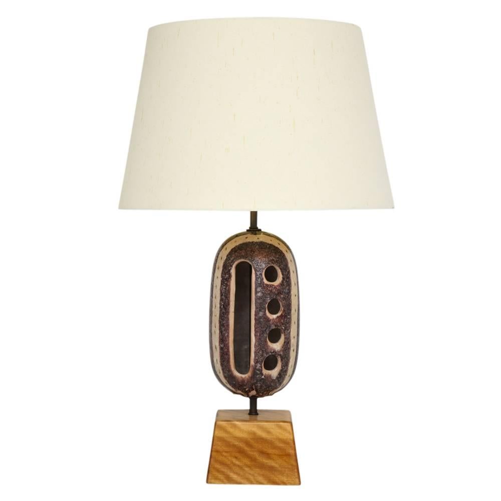 Guido Gambone Ceramic Table Lamp with Cutouts Signed Italy, 1950s. Oblong glazed ceramic with cutout decorations mounted on the original sugar pine base which we refinished. Rewired with silk twist cord and bronzed single socket assembly for