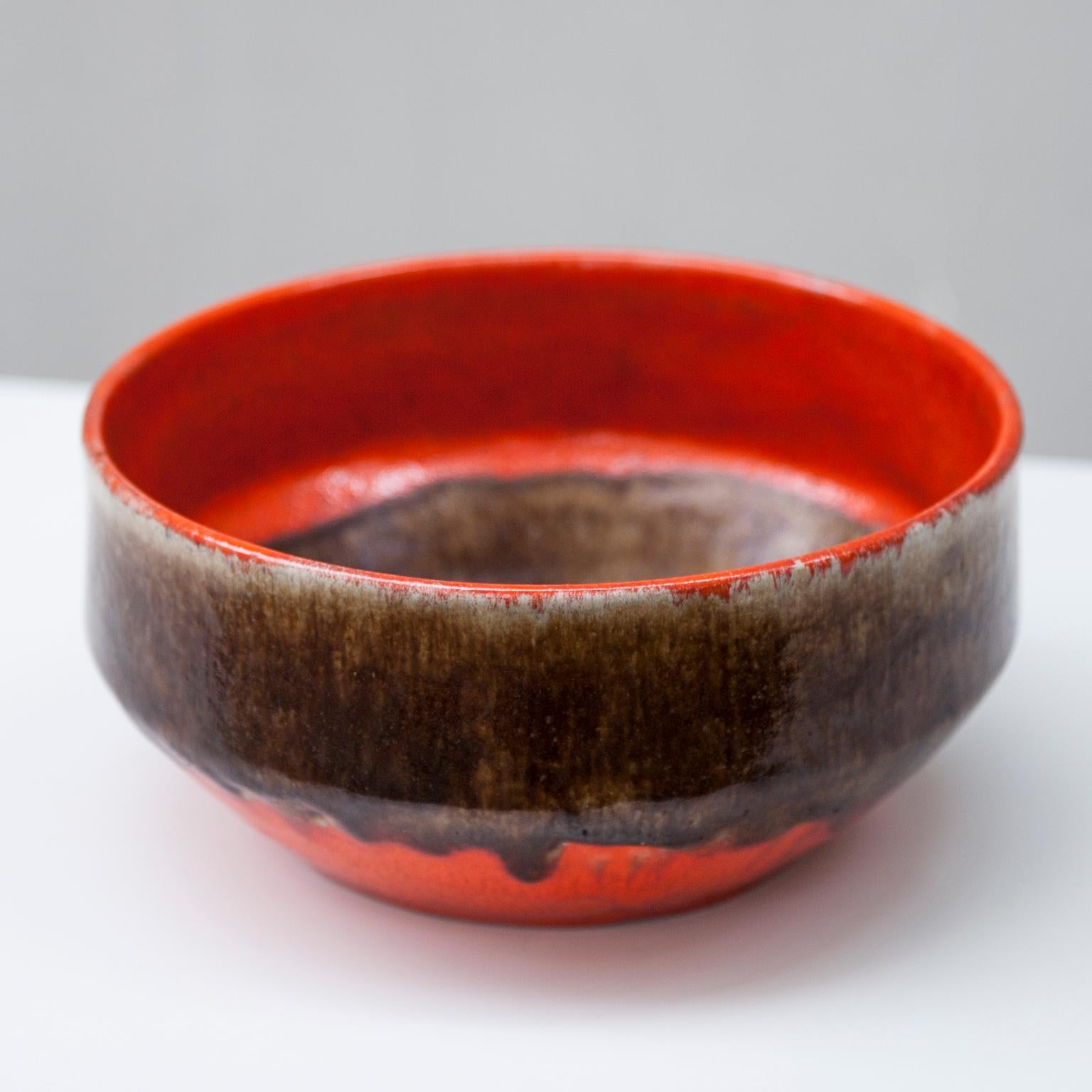 Huge ceramic bowl by Guido Gambone with brown and orange glaze.

Signed on the bottom with the donkey mark.
Guido Gambone (1909 – 1969) is one of the most important and influential Italian ceramic artist in the mid-20th century. He was born in