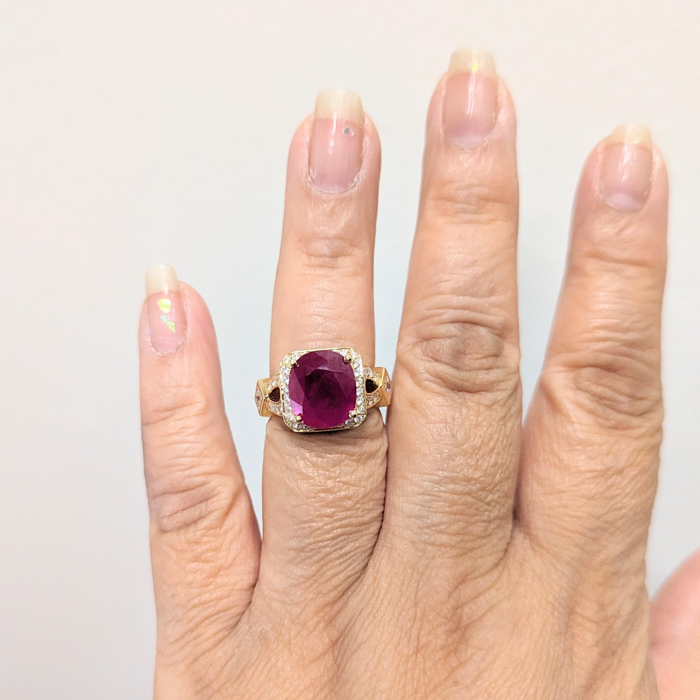 Beautiful Guild certified Burma ruby weighing 6.26 ct. with good quality, white, and bright diamond rounds and squares.  Handmade in 18k yellow gold.  Ring size 7.