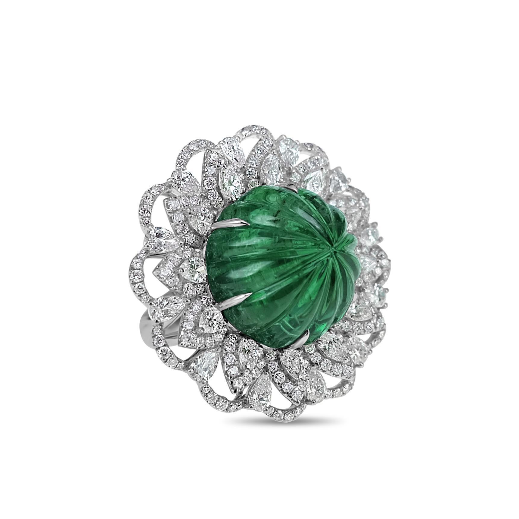 A 22.86 carat Guild Certified Intense Green Emerald Old Carving is set along with 3.22 carats of white brilliant diamond. The emeralds are from Zambia and this cut was very famous during the Moghul era.
The details of the ring are mentioned