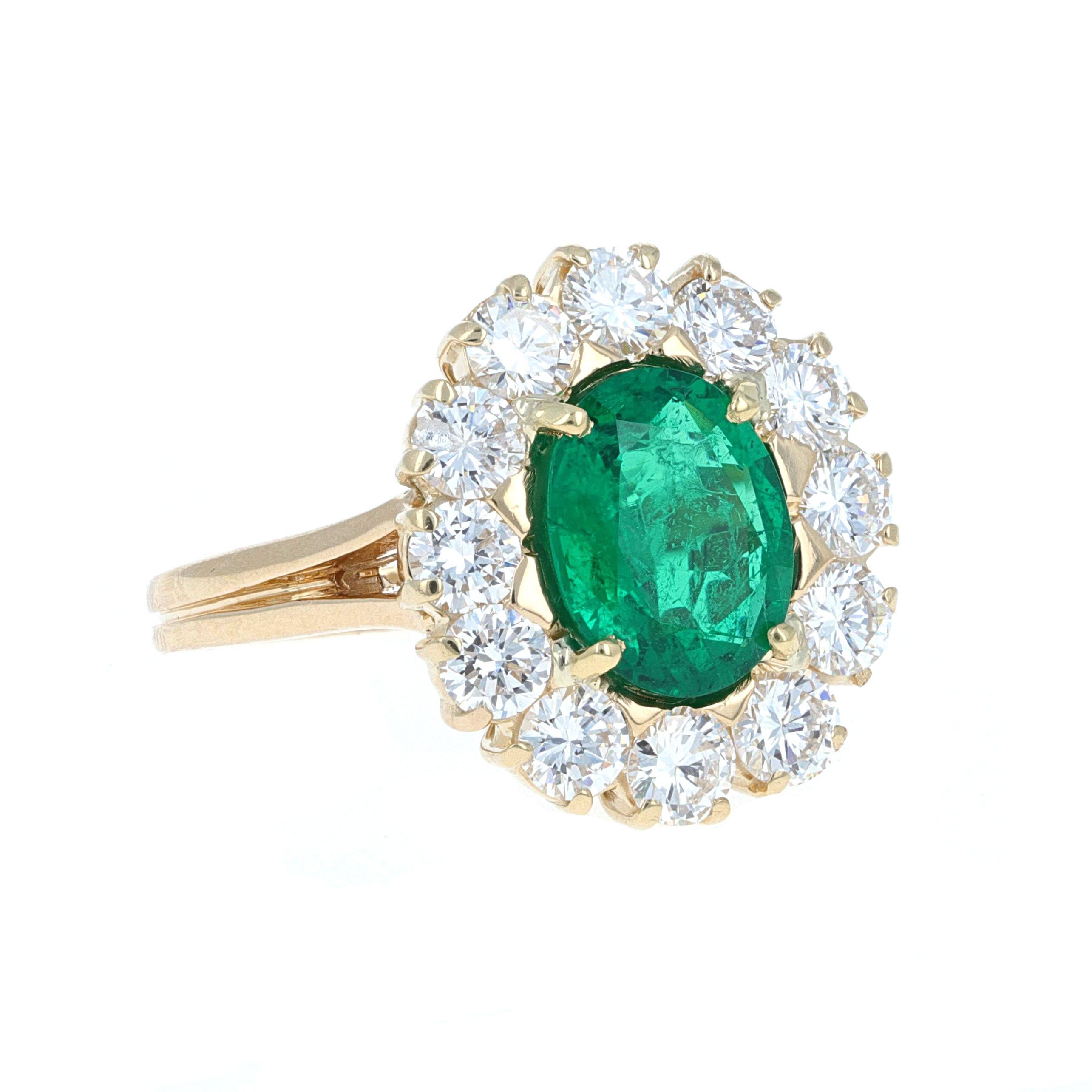 GUILD Lab Certified 2.47 carat oval shape natural emerald with round brilliant diamonds, cocktail ring. The ring is mounted in 18 karat yellow gold and has 12 round brillant cut white diammonds surrounding it. All of the diamonds match in color and