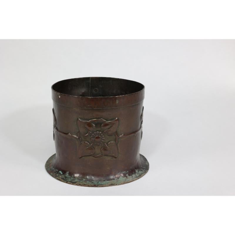 English Guild of Handicraft style of. An Arts & Crafts copper plant pot with two florets For Sale