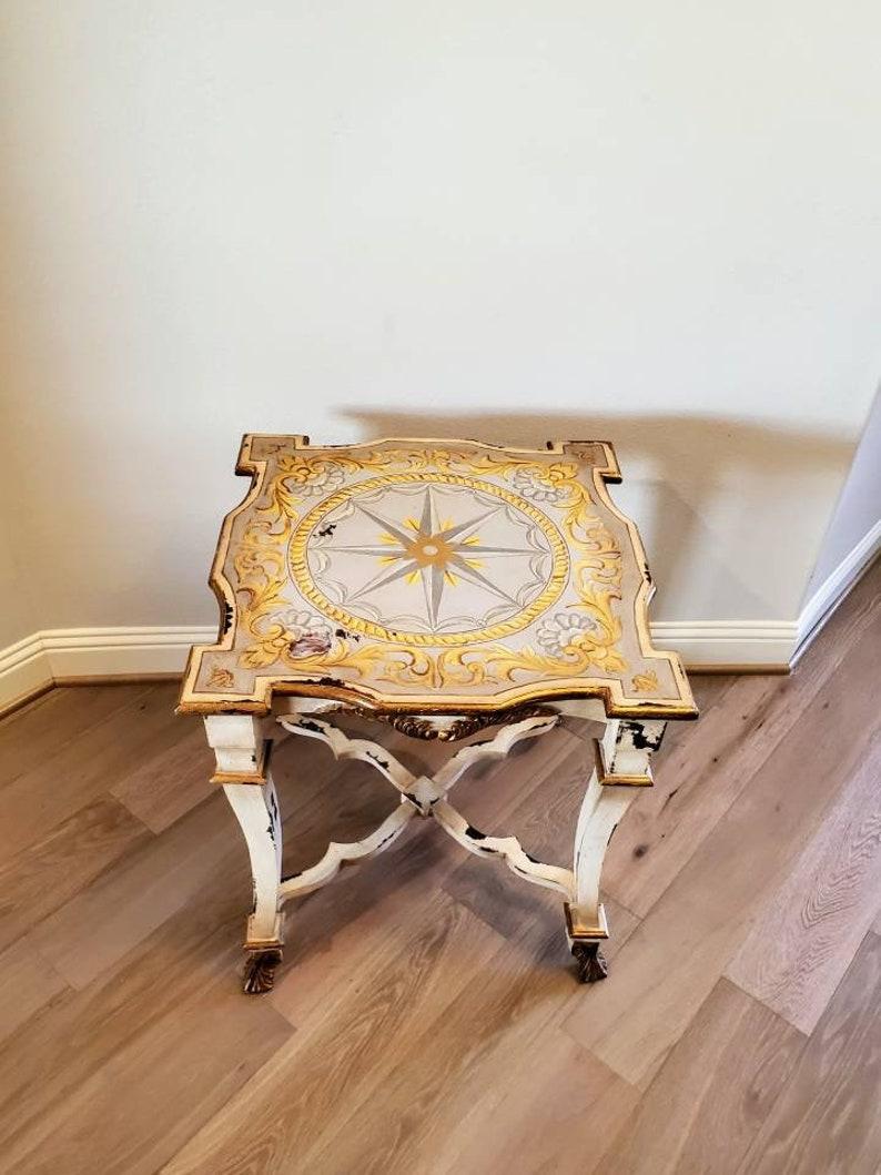 Straight from the home of the late legendary American business magnate, T. Boone Pickens, we present a contemporary hand carved distressed painted white side table by Guildmaster. 

Styled after luxurious antique neoclassical furniture, the