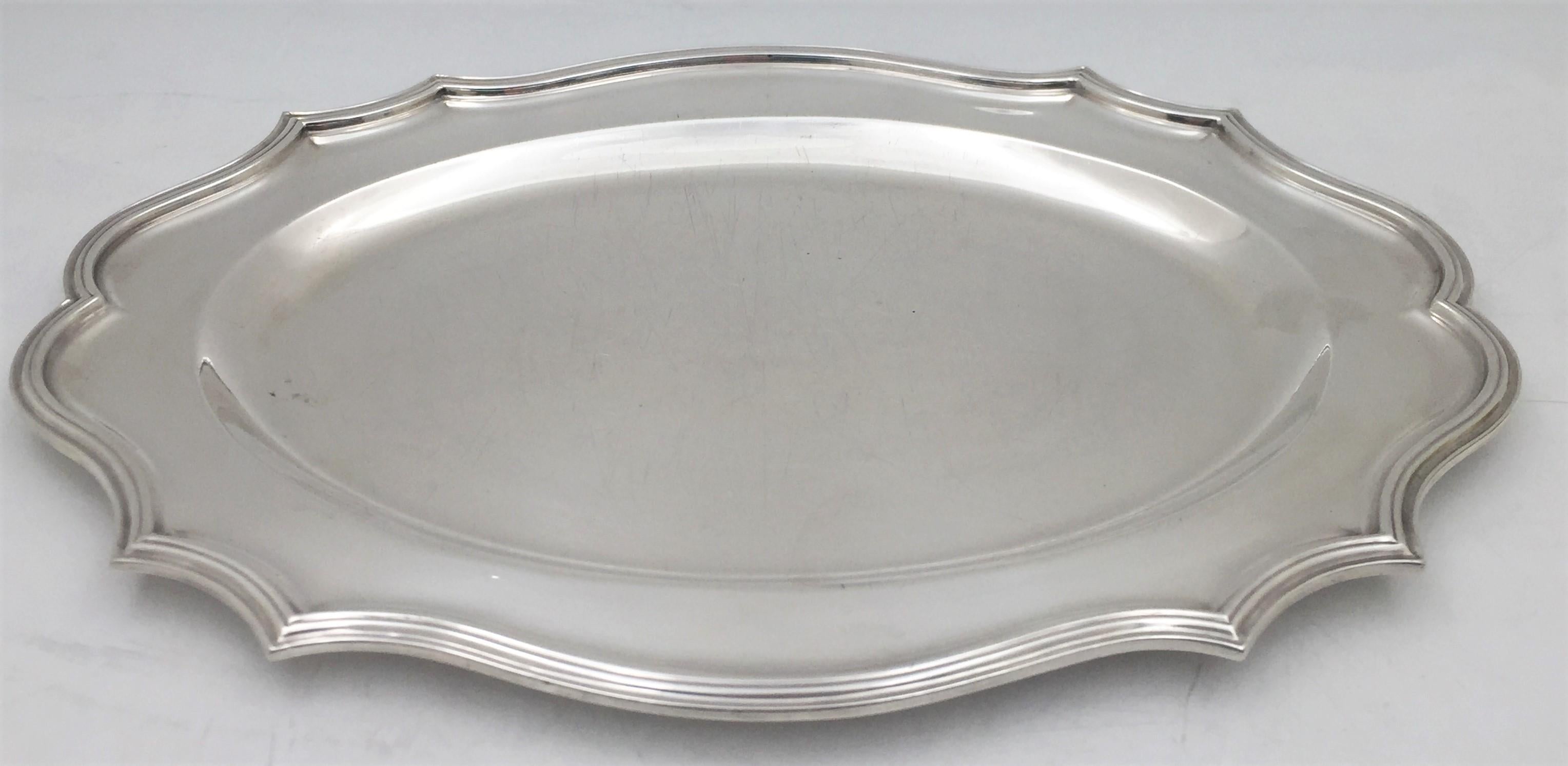 Peter Guille English sterling silver tray or platter from 1939 in Mid-Century Modern style with a beautiful, geometric, and curvilinear design. It measures 14 7/8'' in length by 10 1/4'' in width by 3/4'' in height, weighs 33.4 troy ounces, and