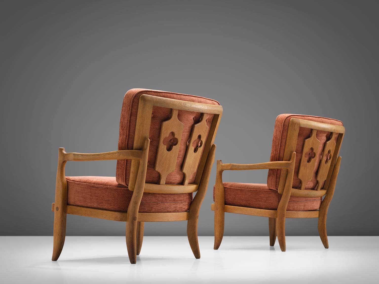 Guillerme and Chambron, red orange fabric, oak, rope, France, 1950s

These sculptural easy chairs are designed by Guillerme and Chambron. The design duo is known for their sculptural, crafted solid oak furniture. These comfortable armchairs have