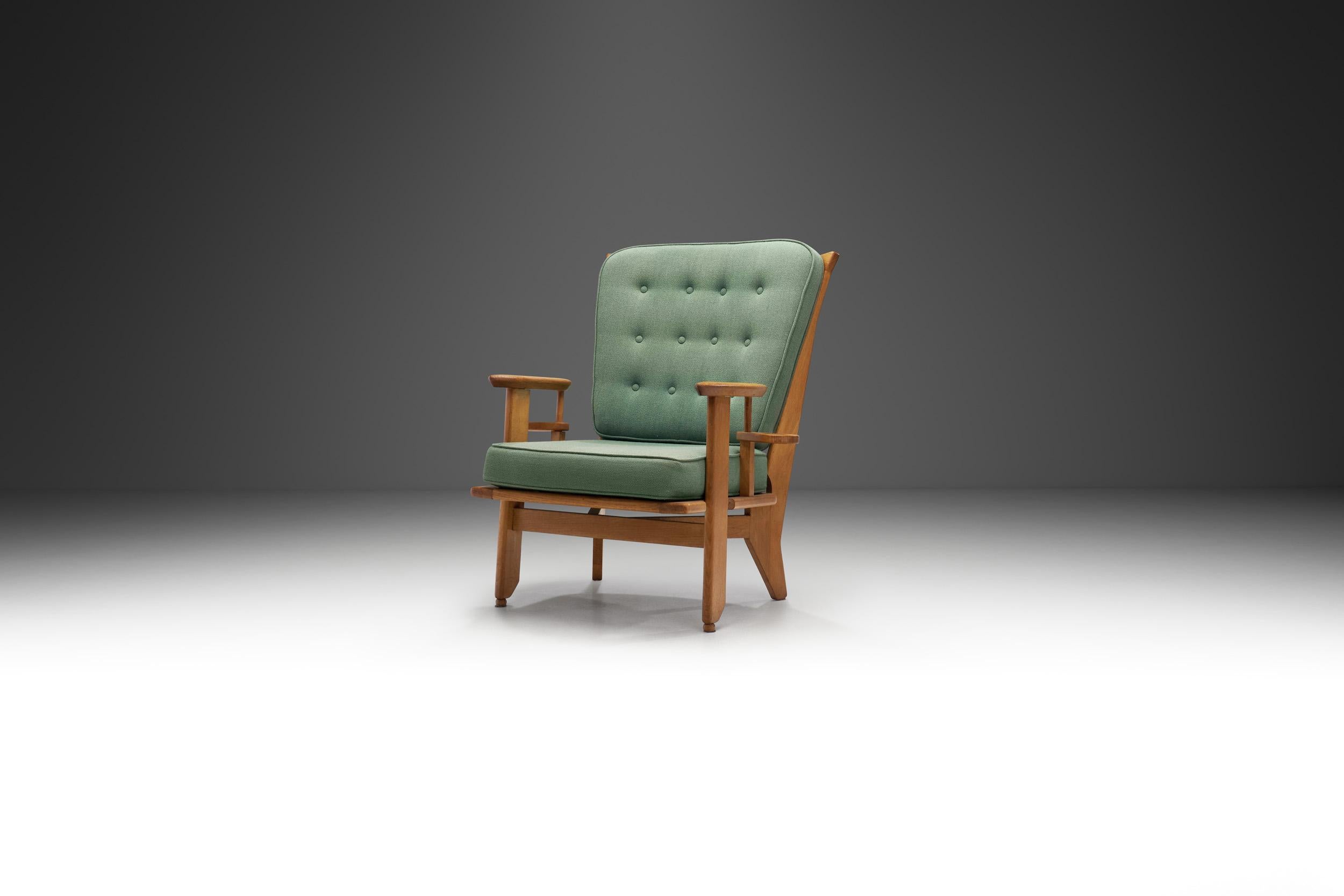 This rare oak “Gentleman” chair is a delightfully unique piece even if measured against the other seating models in the repertoire of the French designer duo, Robert Guillerme and Jacques Chambron. This model truly deserves the title of iconic, both