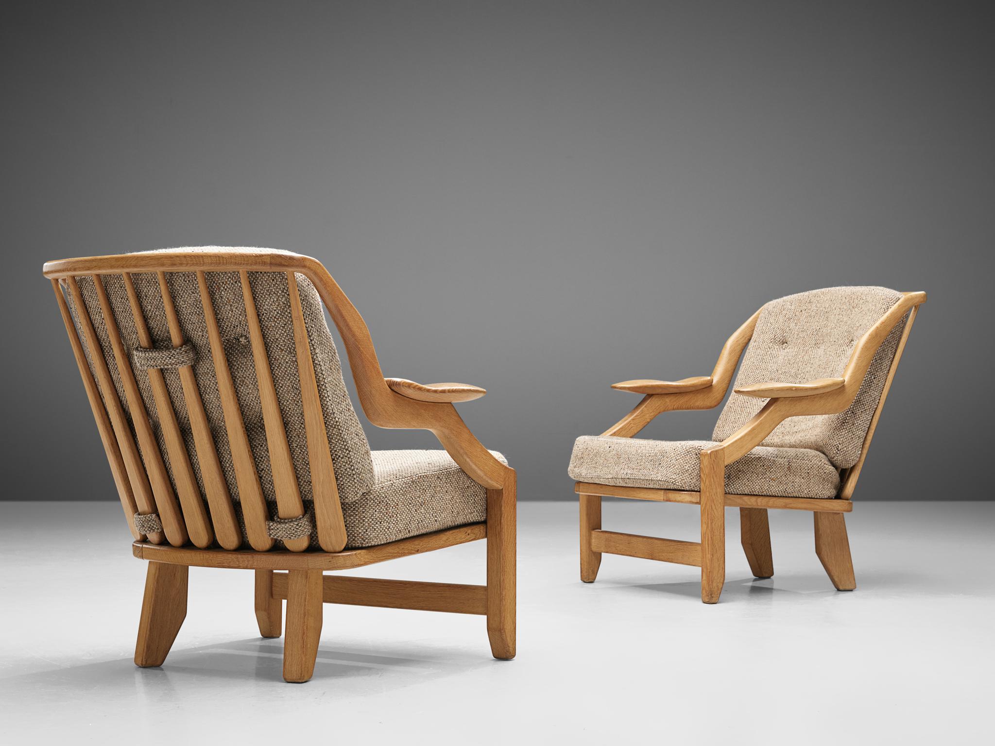 Guillerme & Chambron, lounge chairs in light gray tweed fabric and oak, France 1950s.

This French designer duo is known for their extreme high quality solid oak furniture, from which this set is another great example. These chairs have a very