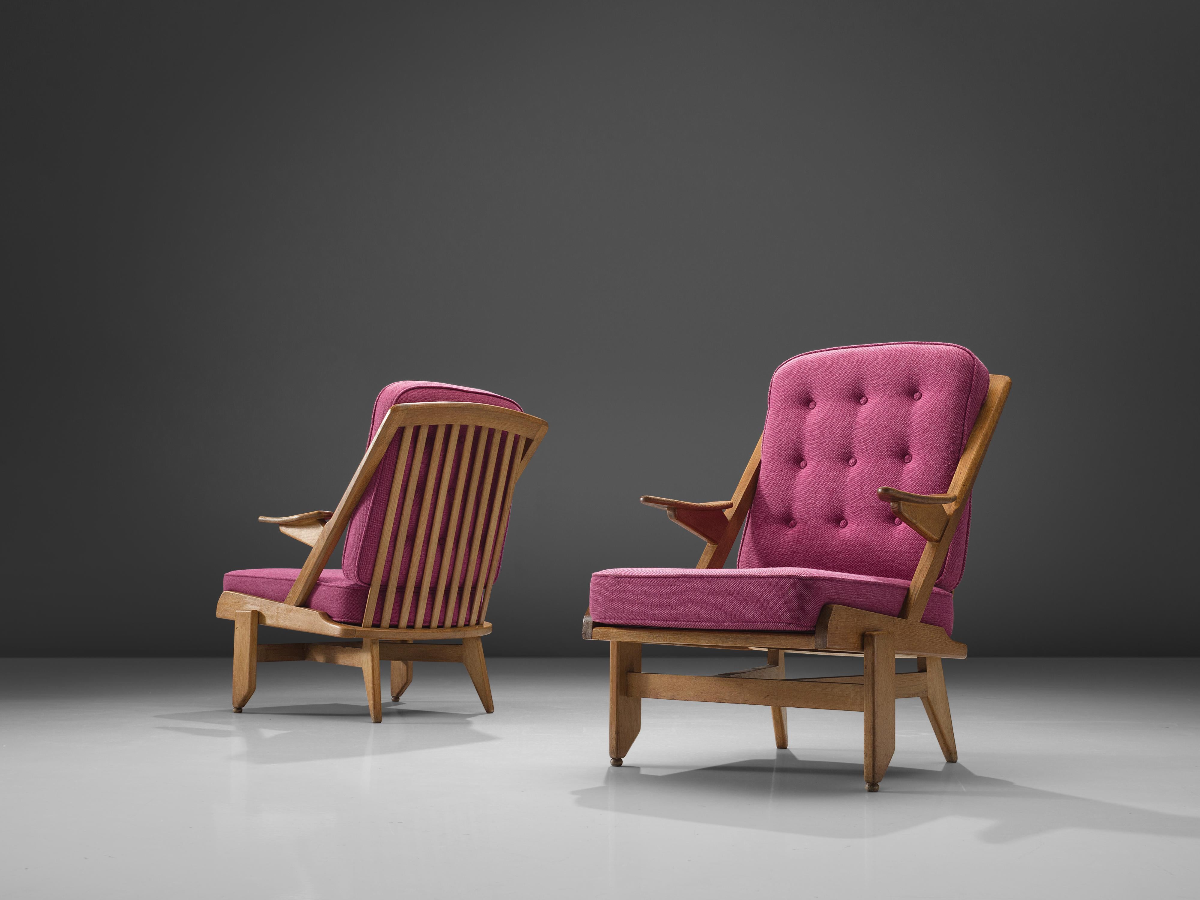 Guillerme and Chambron, pair of lounge chairs, pink fabric, oak, France, 1950s

This French designer duo is known for their extremely high-quality solid oak furniture, from which this set is another great example. These chairs have a very