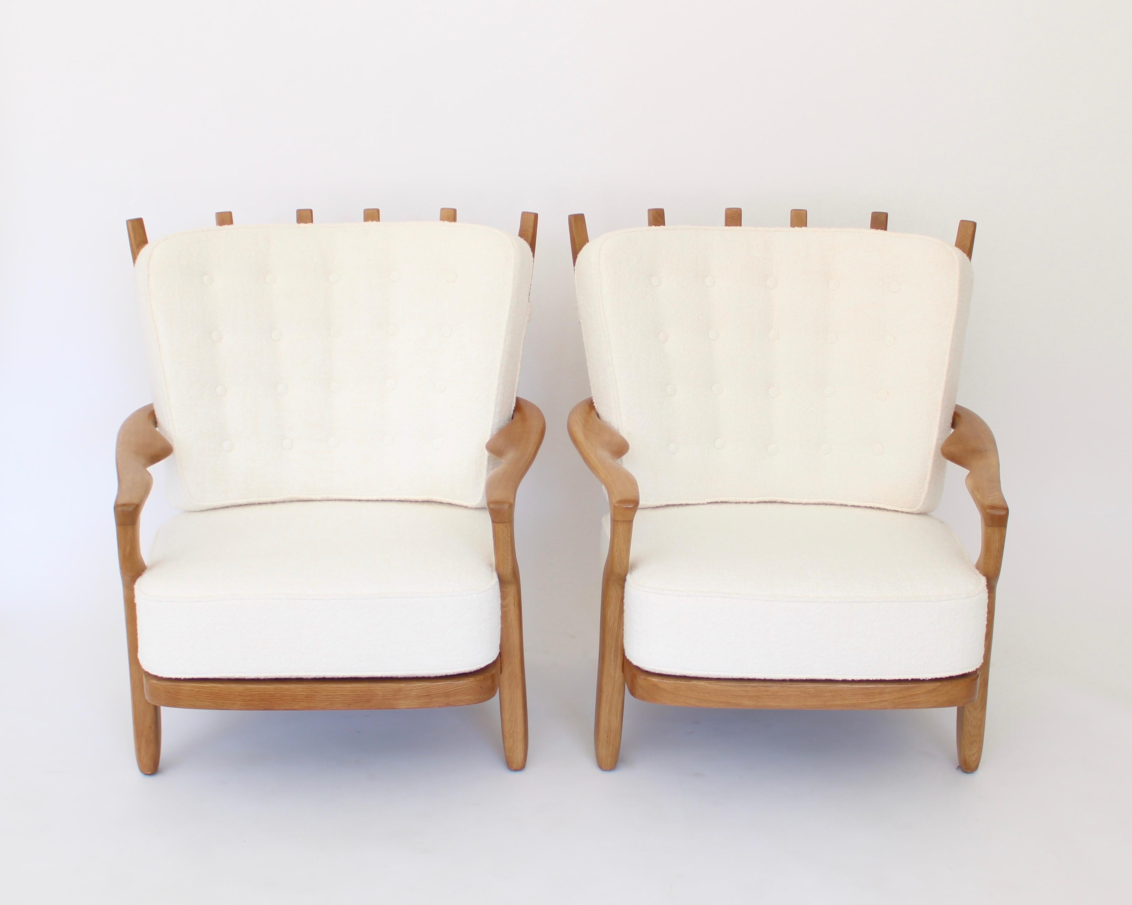 A pair of French oak lounge chairs model Juliette in sculptural carved oak, designed by the French designers Guillerme et Chambron for the French company 