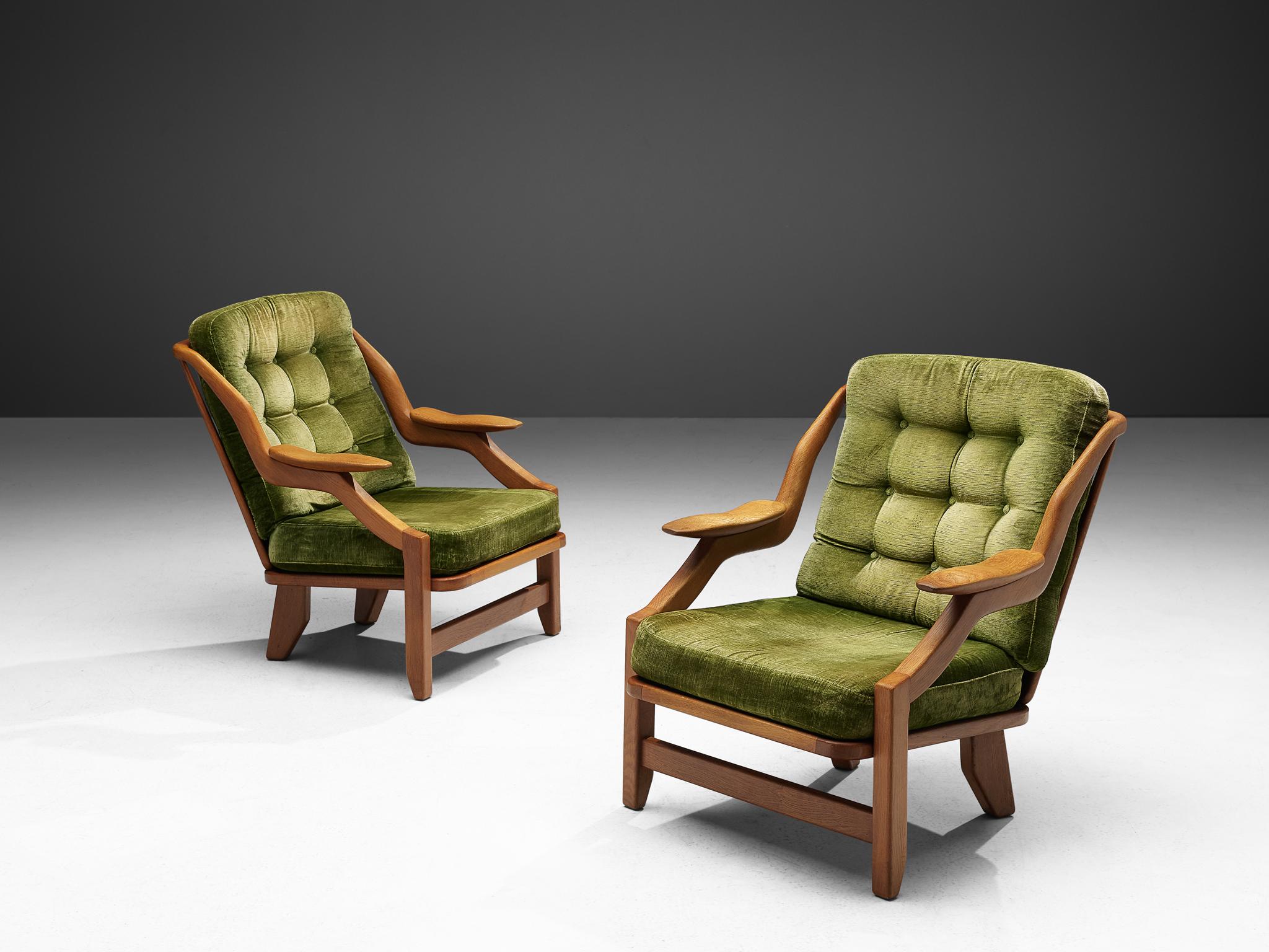 Guillerme & Chambron, set of lounge chairs in green velvet upholstery and oak, France 1950s.

This French designer duo is known for their extreme high quality solid oak furniture, from which this set is another great example. These chairs have a