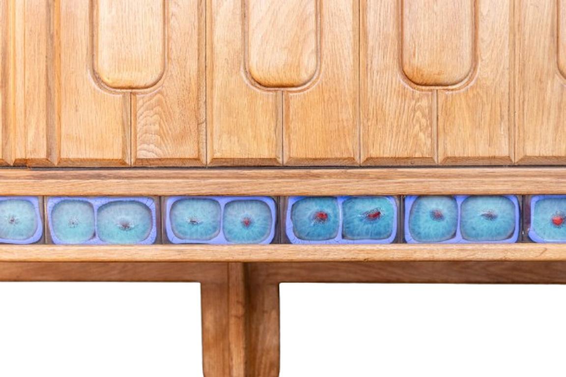 Carved Guillerme and Chambron. Sideboard in light oak and ceramic. Circa 1960. For Sale