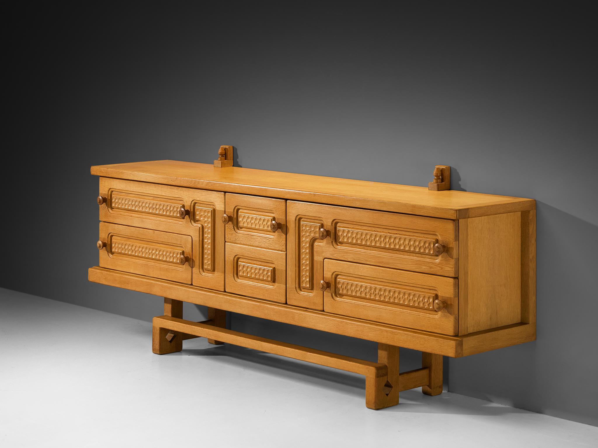 Guillerme et Chambron for Votre Maison, sideboard or credenza, oak, glass, France, 1960s

This exceptional sideboard is a great example where both aesthetics and functionality come into play; elegant in line and practical to use for various