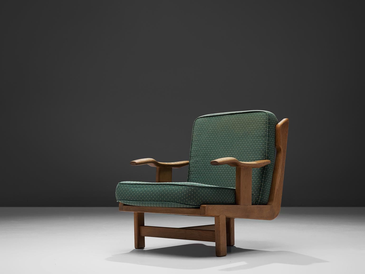 Guillerme & Chambron, oak chairs with green fabric upholstery, France, 1960s.

This chair has a very interesting back and shows a variety of stunning shapes and well designed lines, such as the armrest and the elegant softly edged square on the