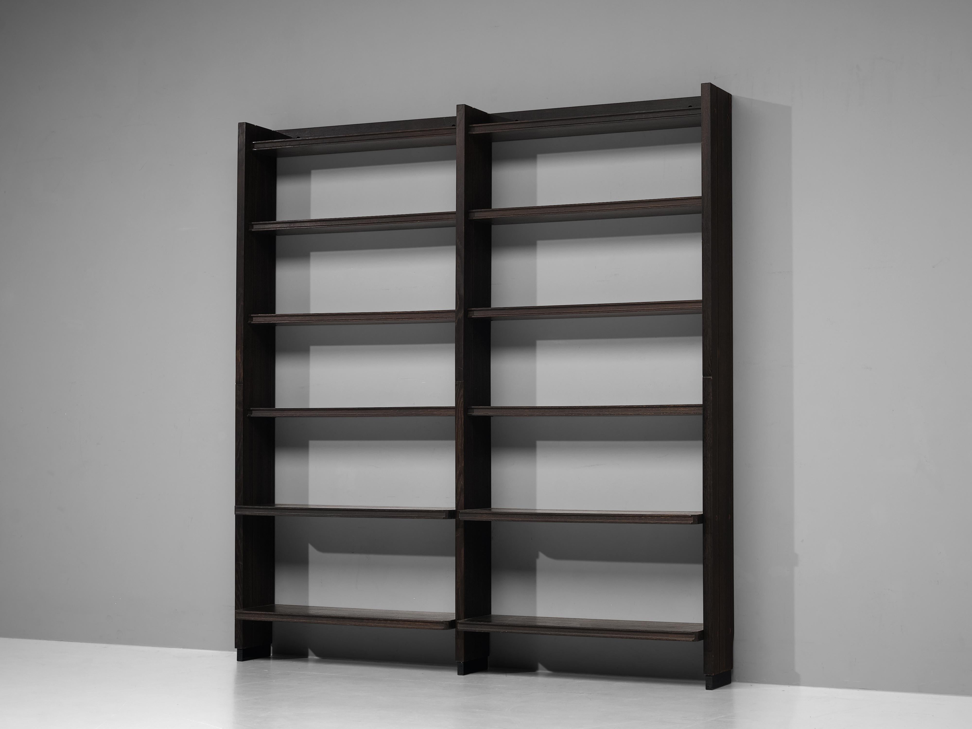 Guillerme & Chambron, bookcase, stained oak, France, 1960s

French bookcase in solid oak by designer duo Guillerme & Chambron. This open bookcase has a simplified yet elegant design. Divded in the middle, each part has six shelves that allow you