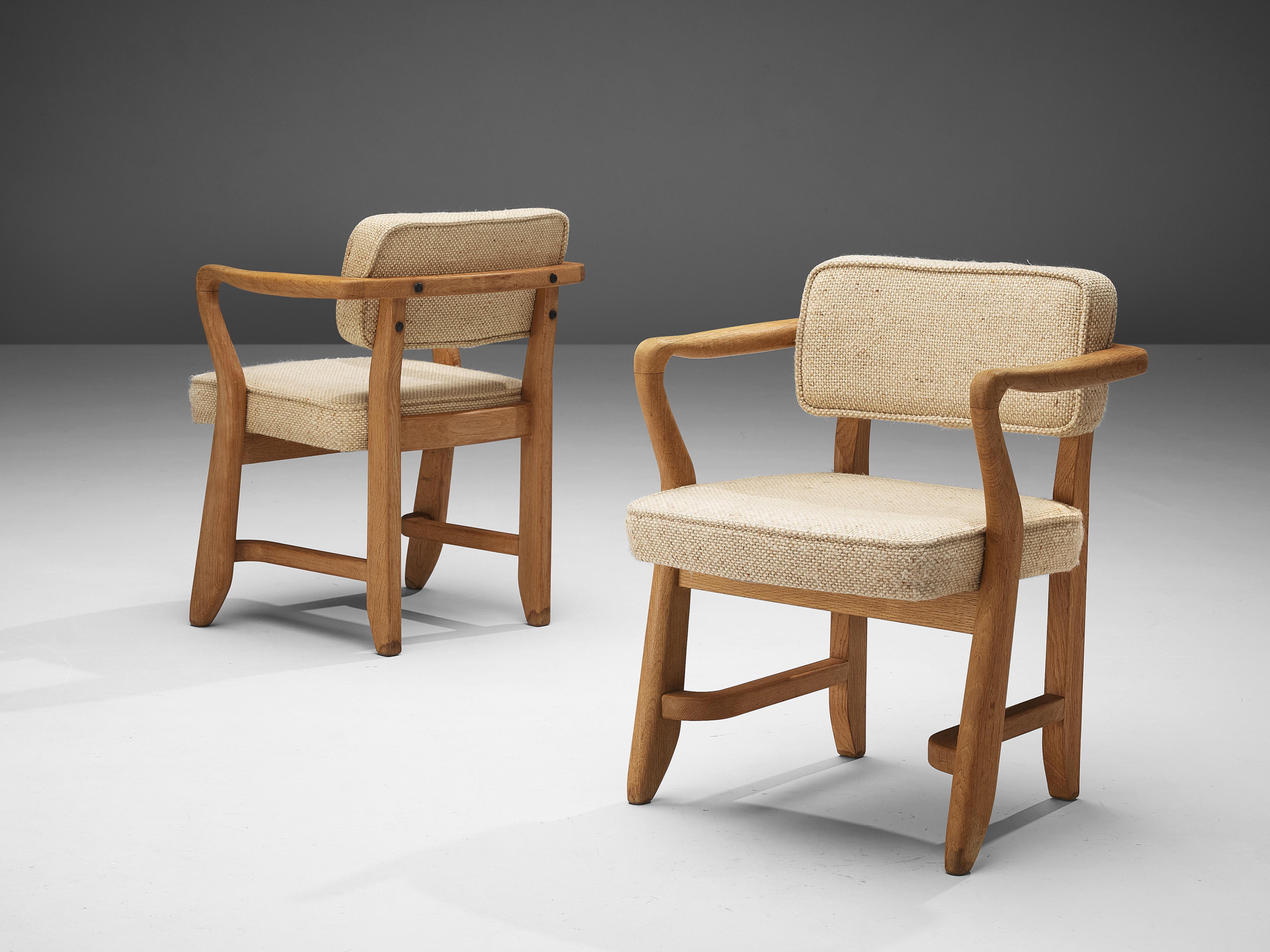 Guillerme & Chambron for Votre Maison, 'Bridge' armchairs, multicolored fabric, oak, France, 1950s

These sculptural easy chairs are designed by Guillerme and Chambron. The duo is known for their high quality solid oak furniture. These chairs are