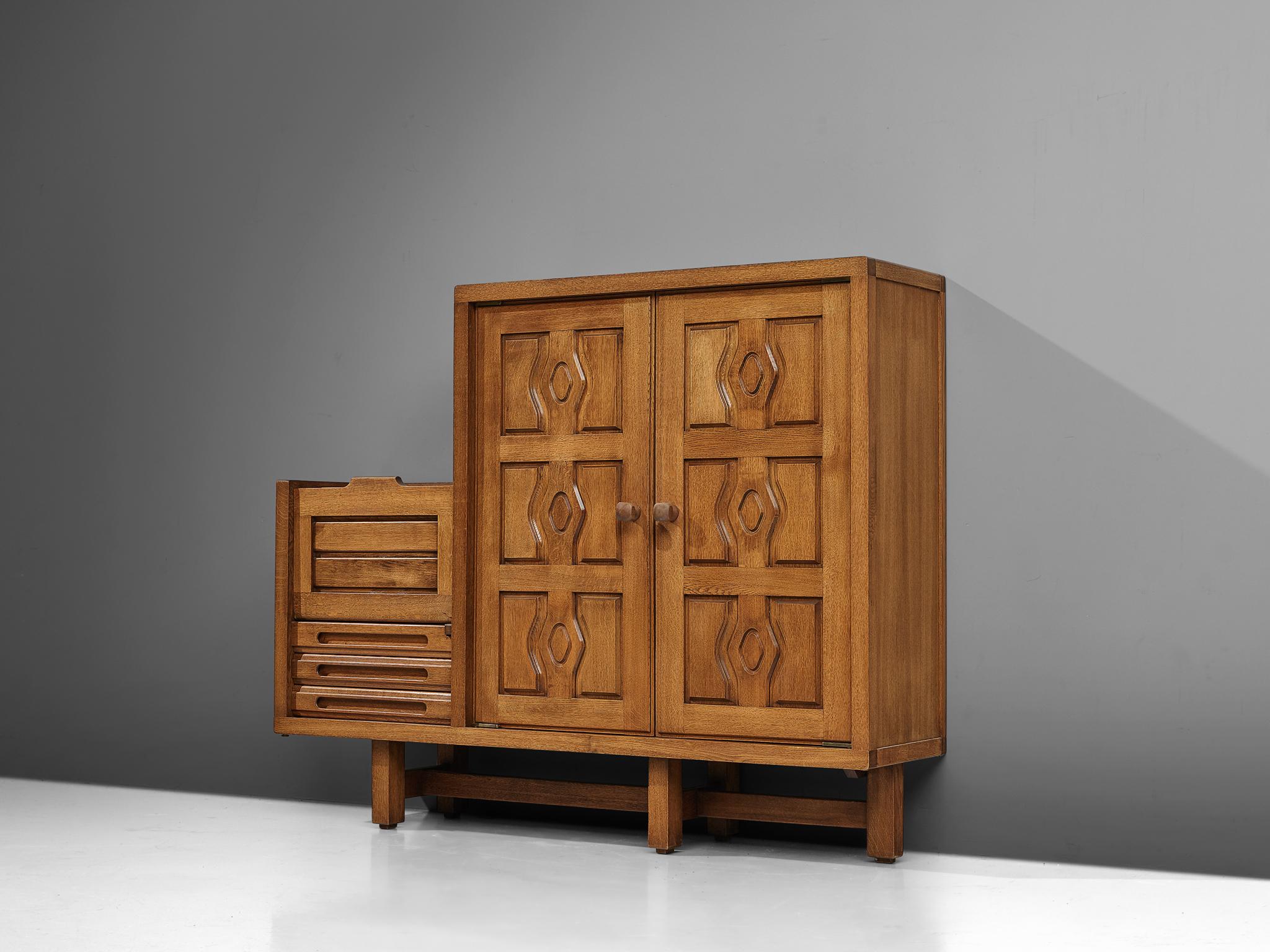 Guillerme et Chambron for Votre Maison, cabinet, model 'Thierry', oak, France, 1960s

This 'Thierry' case piece is created by Guillerme and Chambron. The design is characterized by a sophisticated composition created by means of the arrangement of