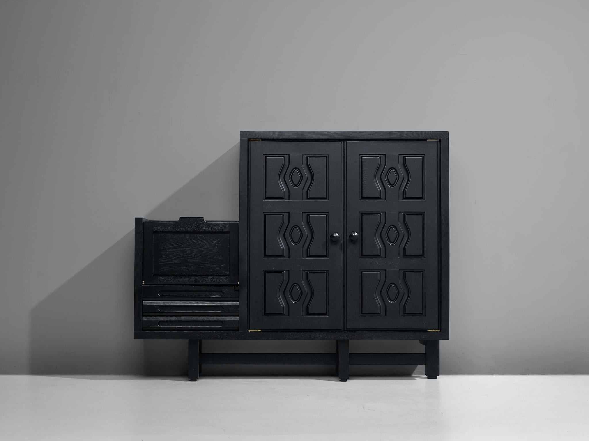 Guillerme & Chambron, cabinet, model 'Thierry', oak, France, 1960s.

This mischievous sideboard mirrors the European Gothic Revival period of the nineteenth century by means of the heavy black stained wood. The design seamlessly blends with any