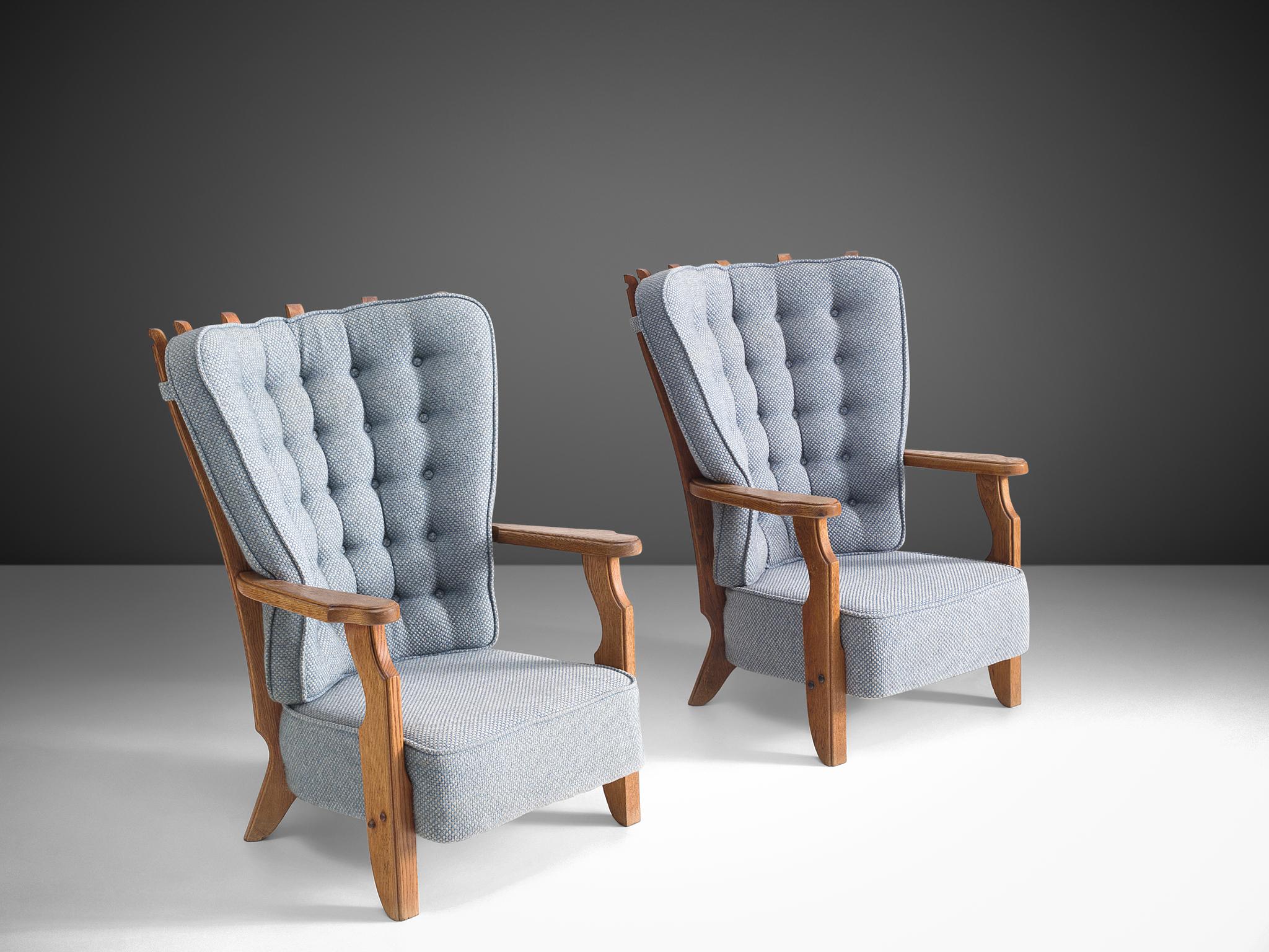 Guillerme et Chambron, pair of lounge chairs, grey blue upholstery, oak, France, 1960s. 

Guillerme and Chambron are known for their high quality solid oak furniture, from which this is another great example. These chairs have an interesting,
