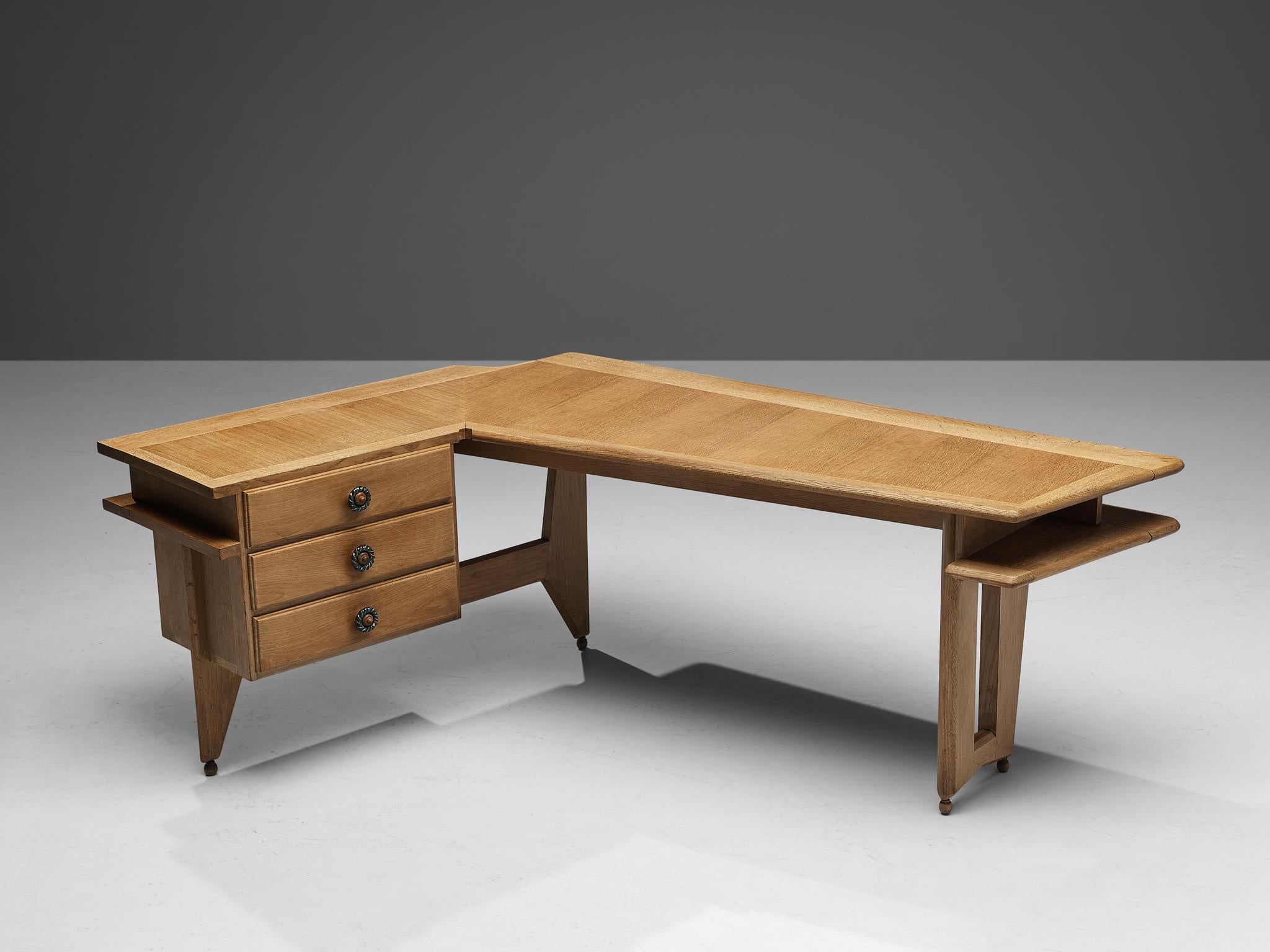 Guillerme et Chambron, corner desk, oak, ceramic, France, 1960s.

This writing desk is executed in solid oak by French designers Guillerme et Chambron. The elegant corner desk shows interesting details. First there is the top which is based on a