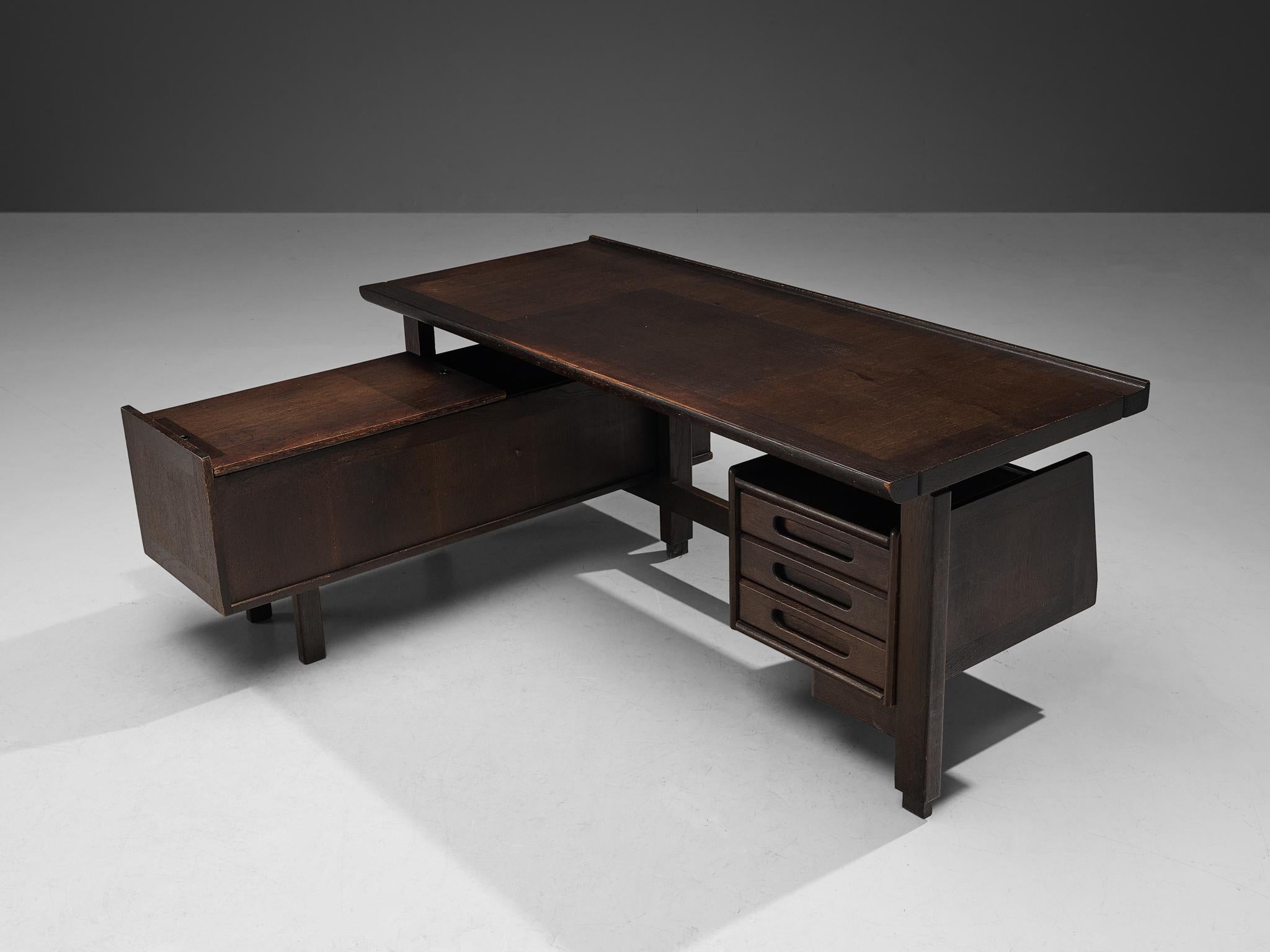 Guillerme et Chambron, corner desk, stained oak, France, 1960s

This executive desk shows the fine craftsmanship and aesthetic characteristics of designer duo Guillerme and Chambron. The stained oak has aged beautifully. The basic construction and