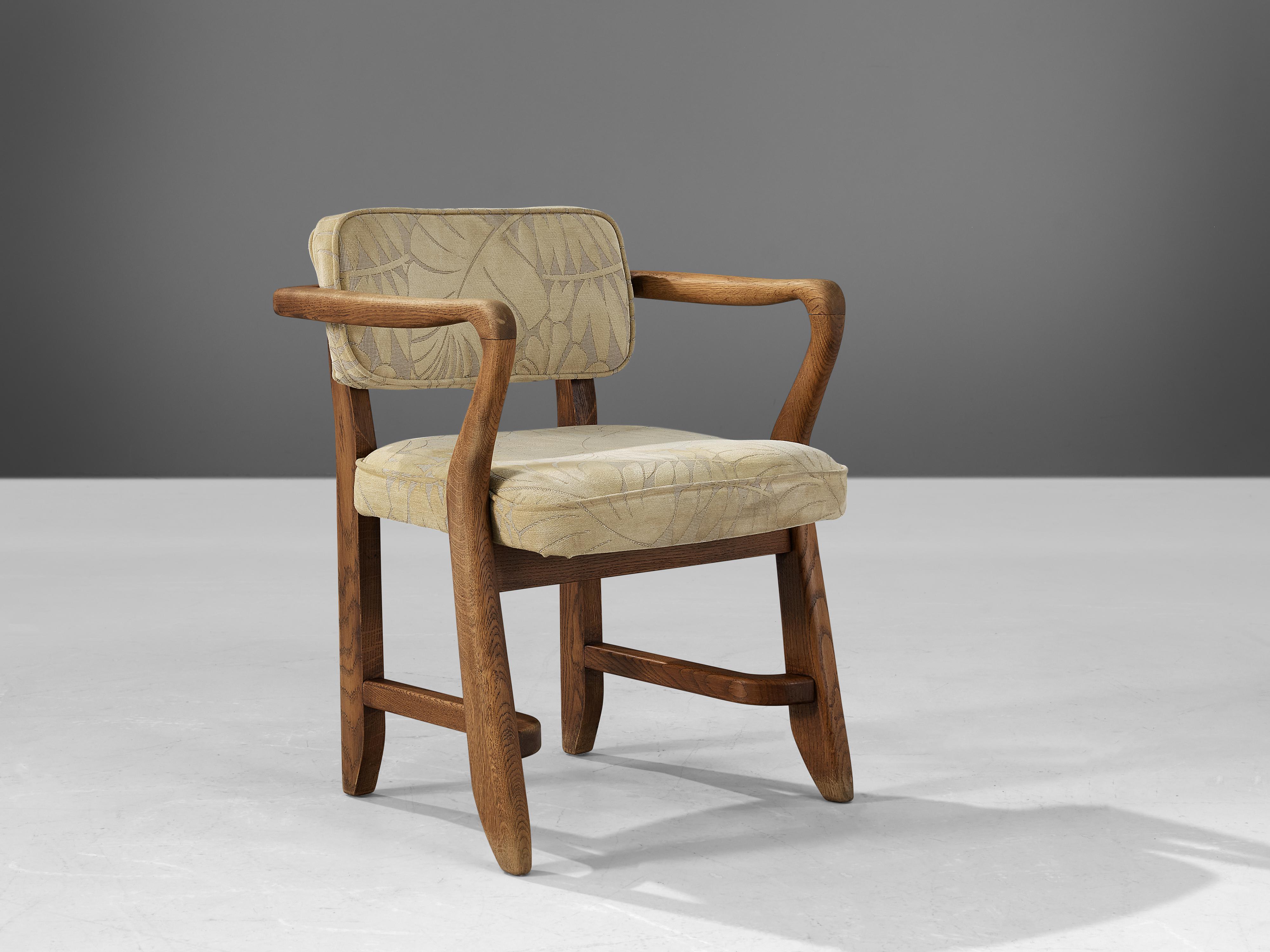 Guillerme & Chambron, 'Denis' armchairs, floral fabric, oak, France, 1950s

This sculptural easy chair is designed by Guillerme & Chambron. The duo is known for their high quality solid oak furniture. The sculptural armchair has an interesting