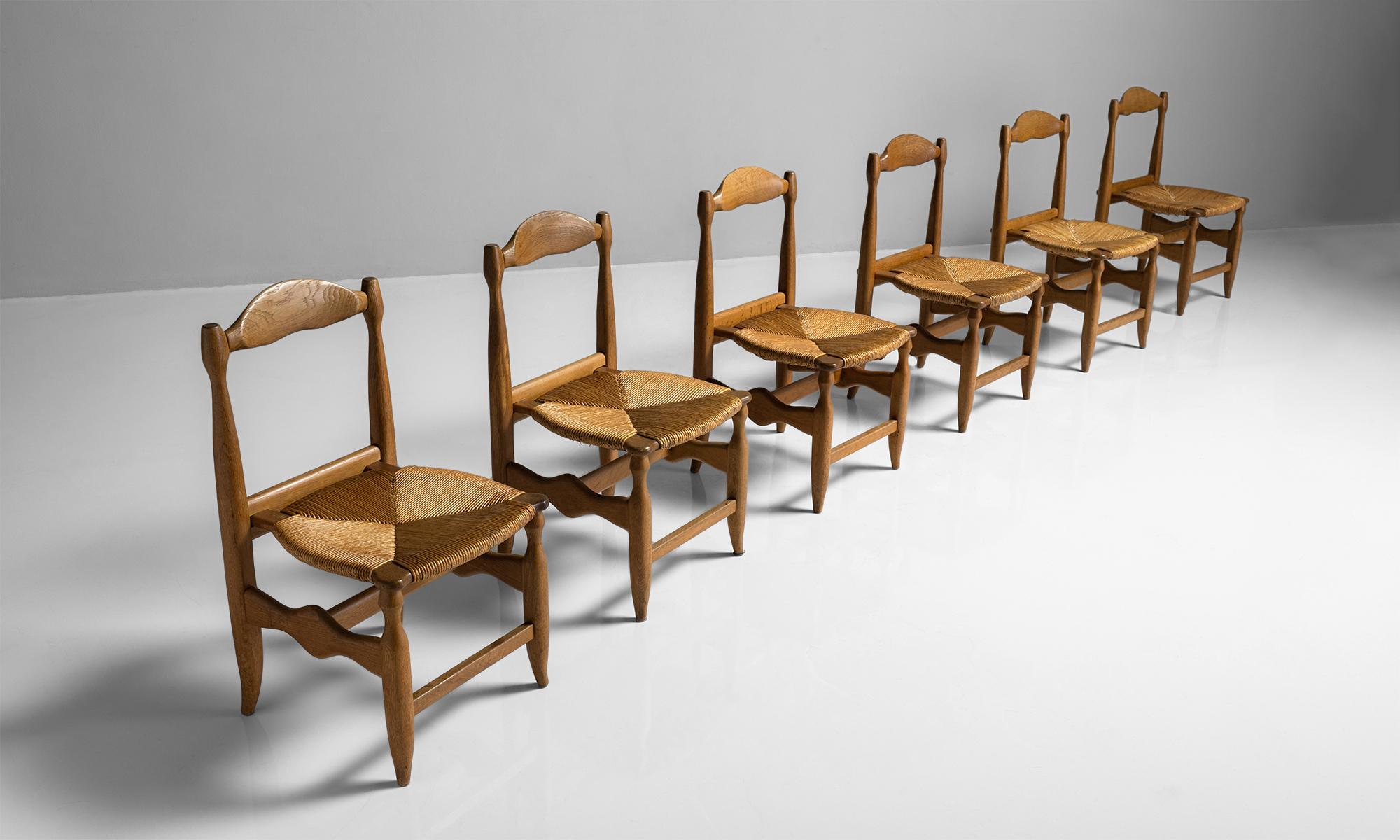 Guillerme & Chambron dining chairs set of six,

France, circa 1950

Votre Maison edition chairs with carved frame and rush seat.