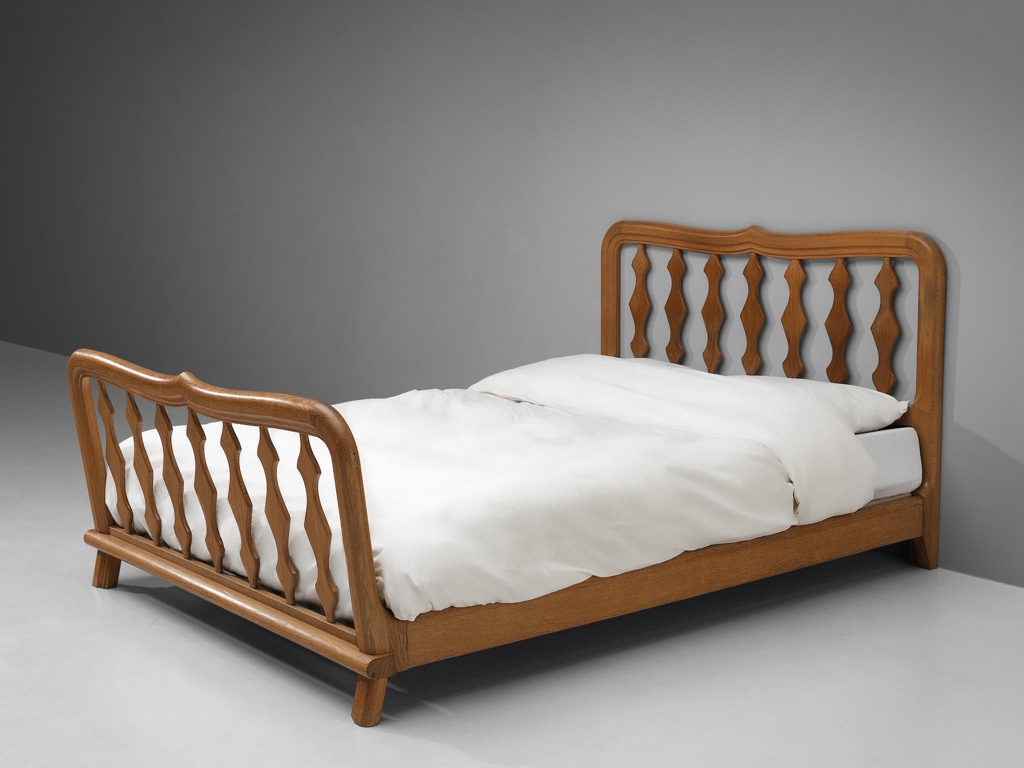 Guillerme et Chambron, double bed, oak, France, 1960s

This bed's main feature is obvious: It's all about the wood work. The excellent crafted frame has stunning sculpted detailing on the slats, which gives it a very luxurious and cosy feel to lie