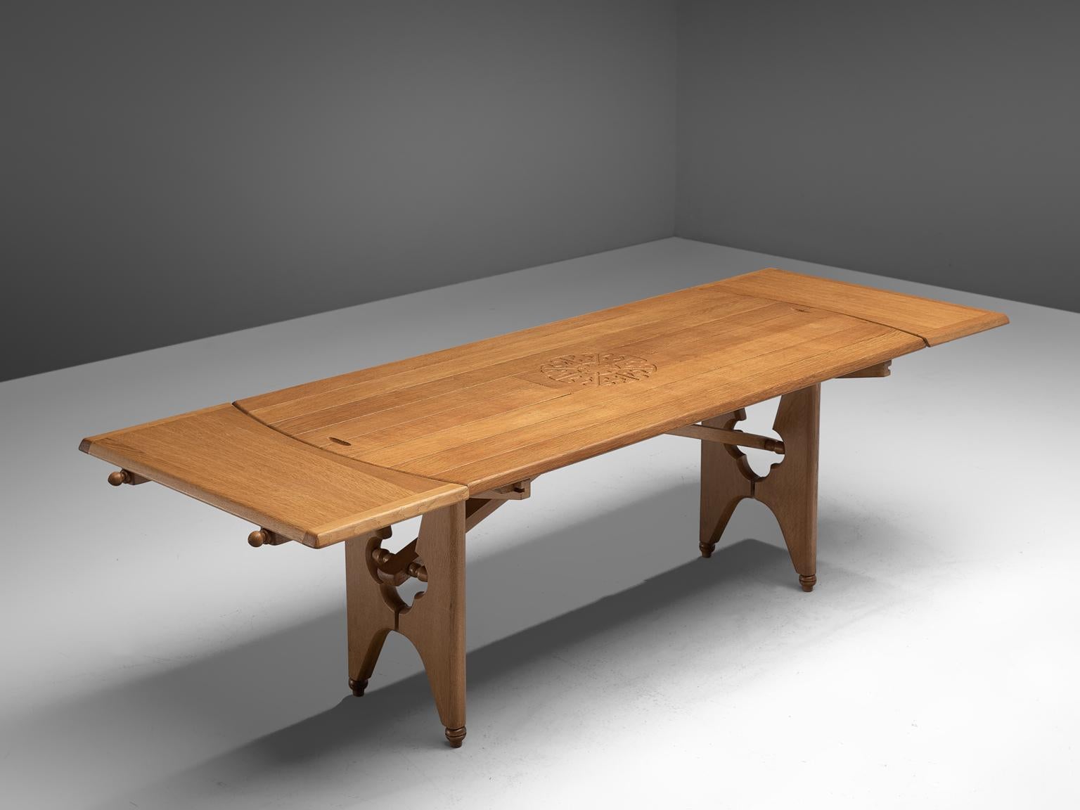Guillerme et Chambron, dining table, oak, France, 1960s.

Extendable dining table in solid oak by French designers Guillerme et Chambron. This elegant table shows interesting details. Most attractive are the stunning sculpted legs that show