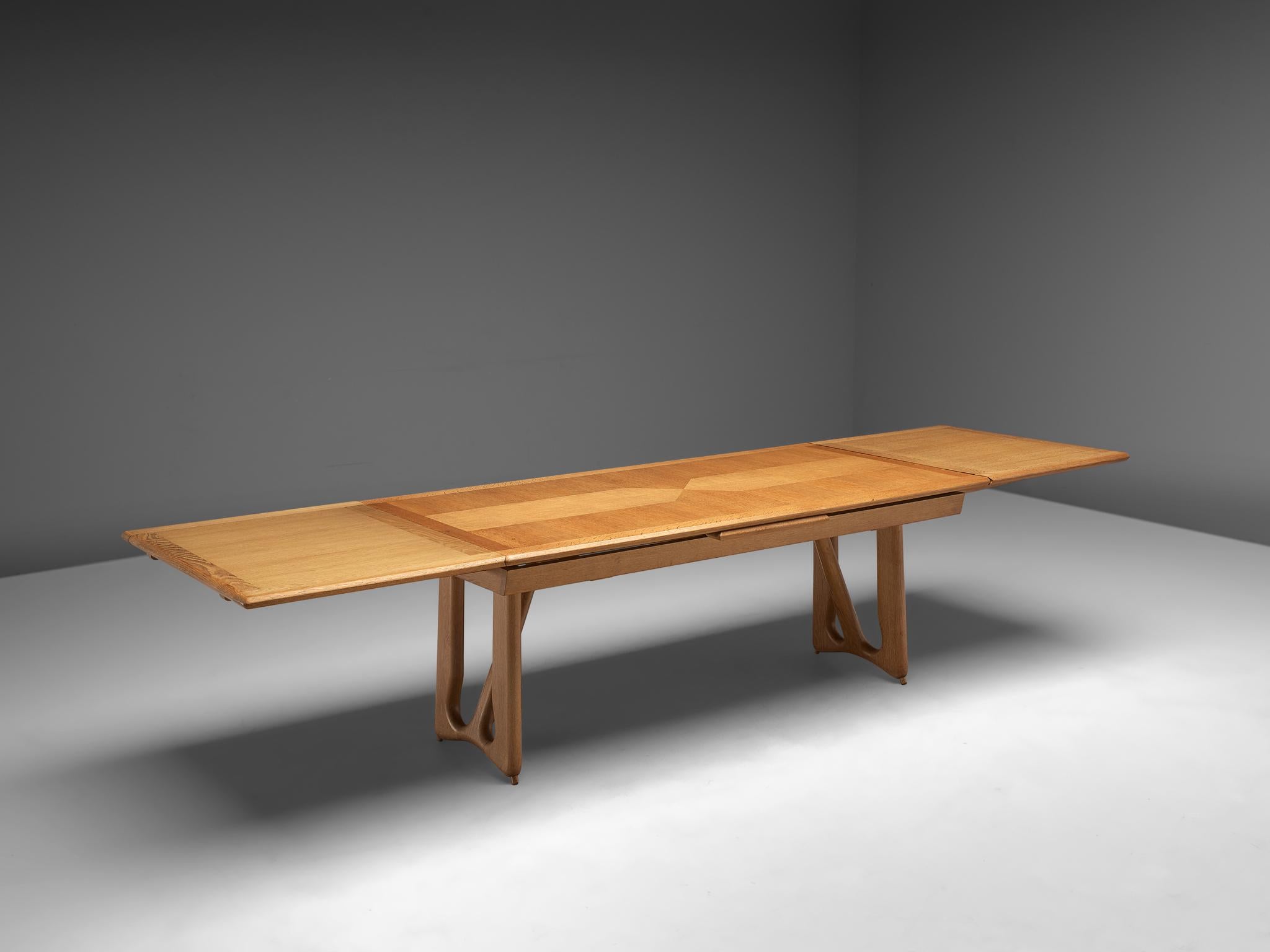 Guillerme et Chambron, dining table, oak, France, 1965.

Extendable dining table in solid oak by French designers Guillerme et Chambron. This elegant table shows interesting details. Most attractive is the inlayed top. These graphical patterns