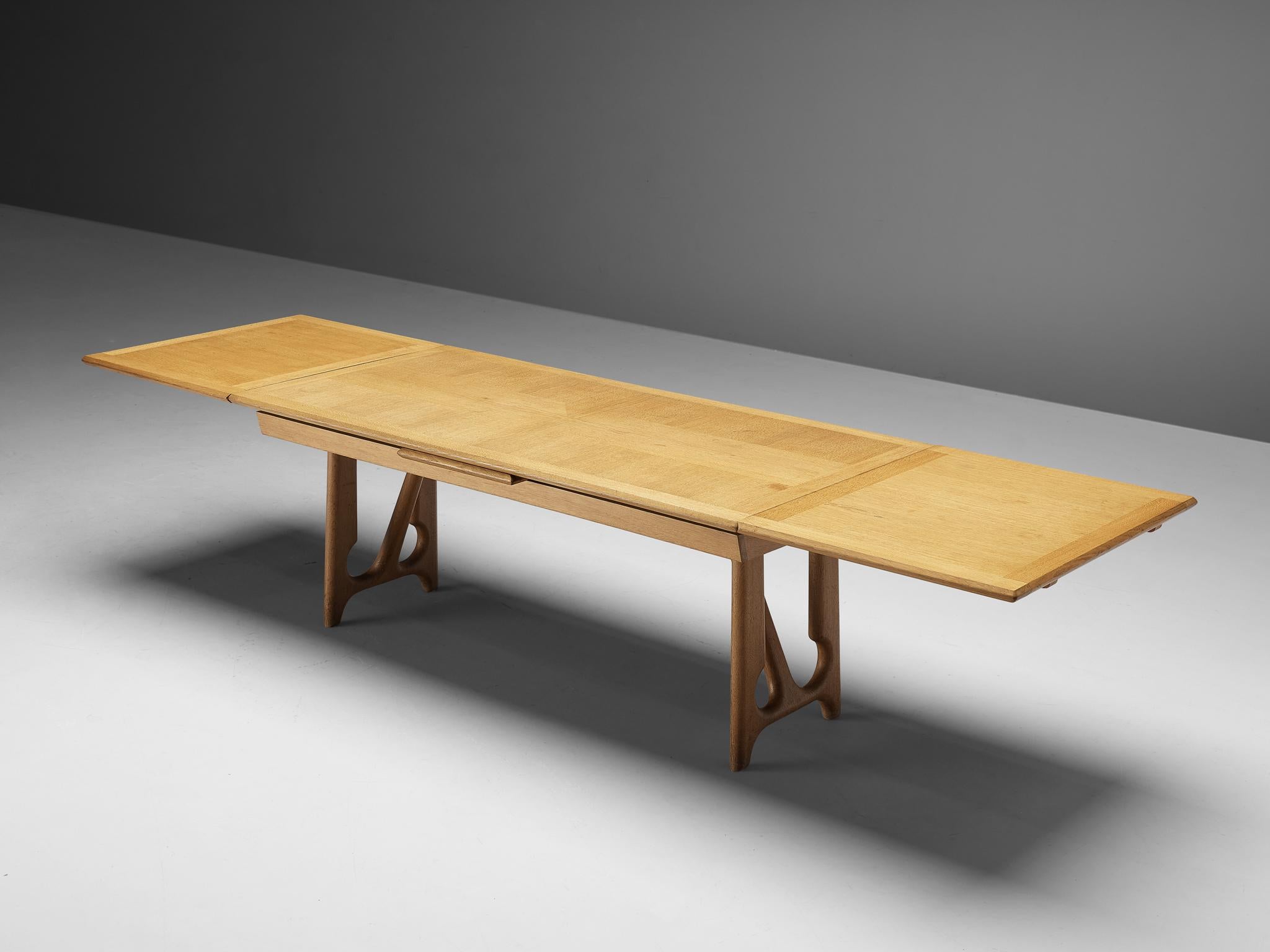 Guillerme & Chambron, dining table, oak, France, 1965.

Extendable dining table in solid oak by French designers Guillerme et Chambron. This elegant table shows interesting details. Most attractive is the inlayed top. These graphical patterns show