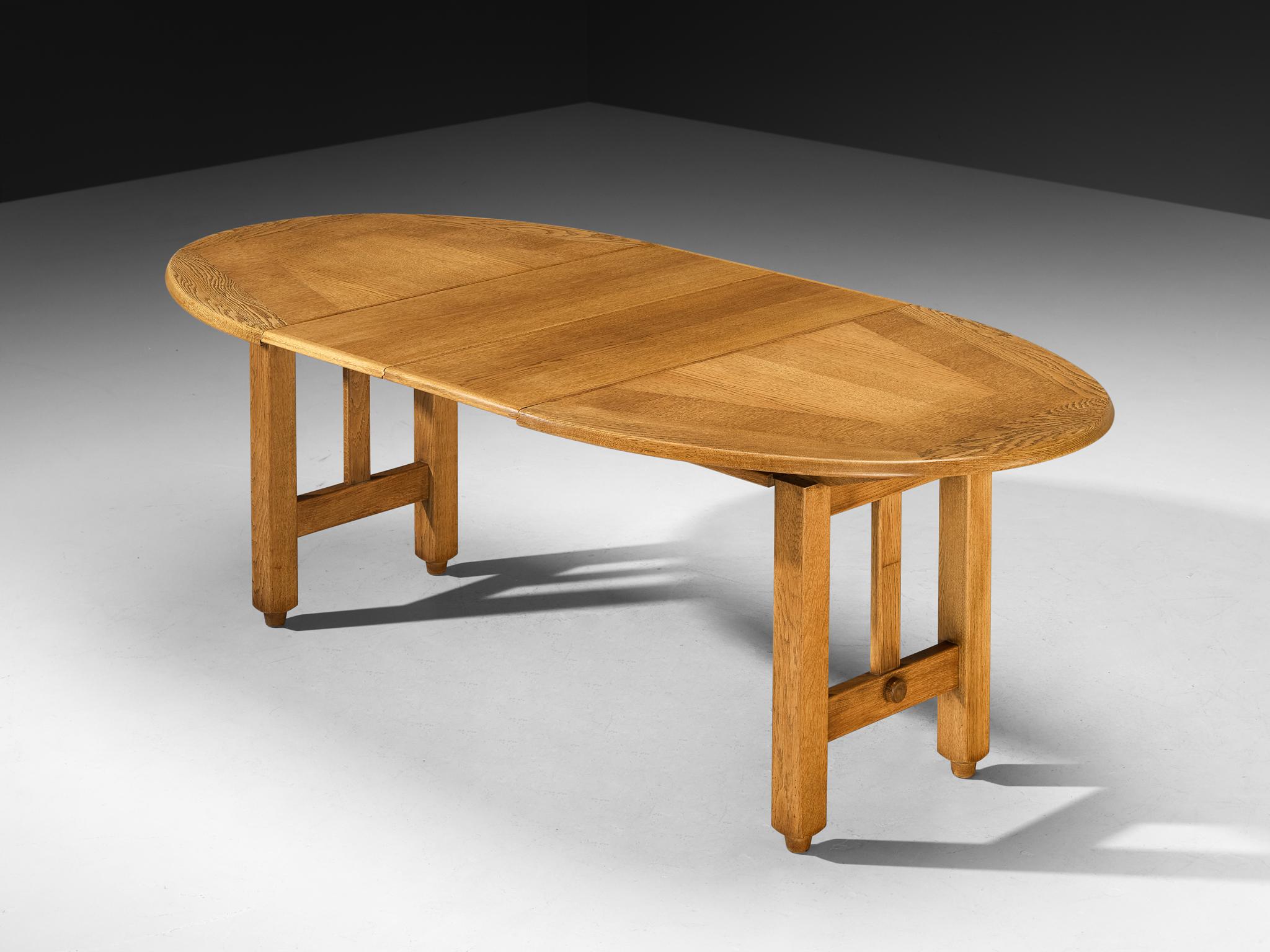 Guillerme et Chambron, extendable dining table, oak, 1960s

Round shaped dining table with inlayed top, designed by the French designer duo Guillerme & Chambron. This extendable table in solid oak comes with two additional leaves, which makes it a