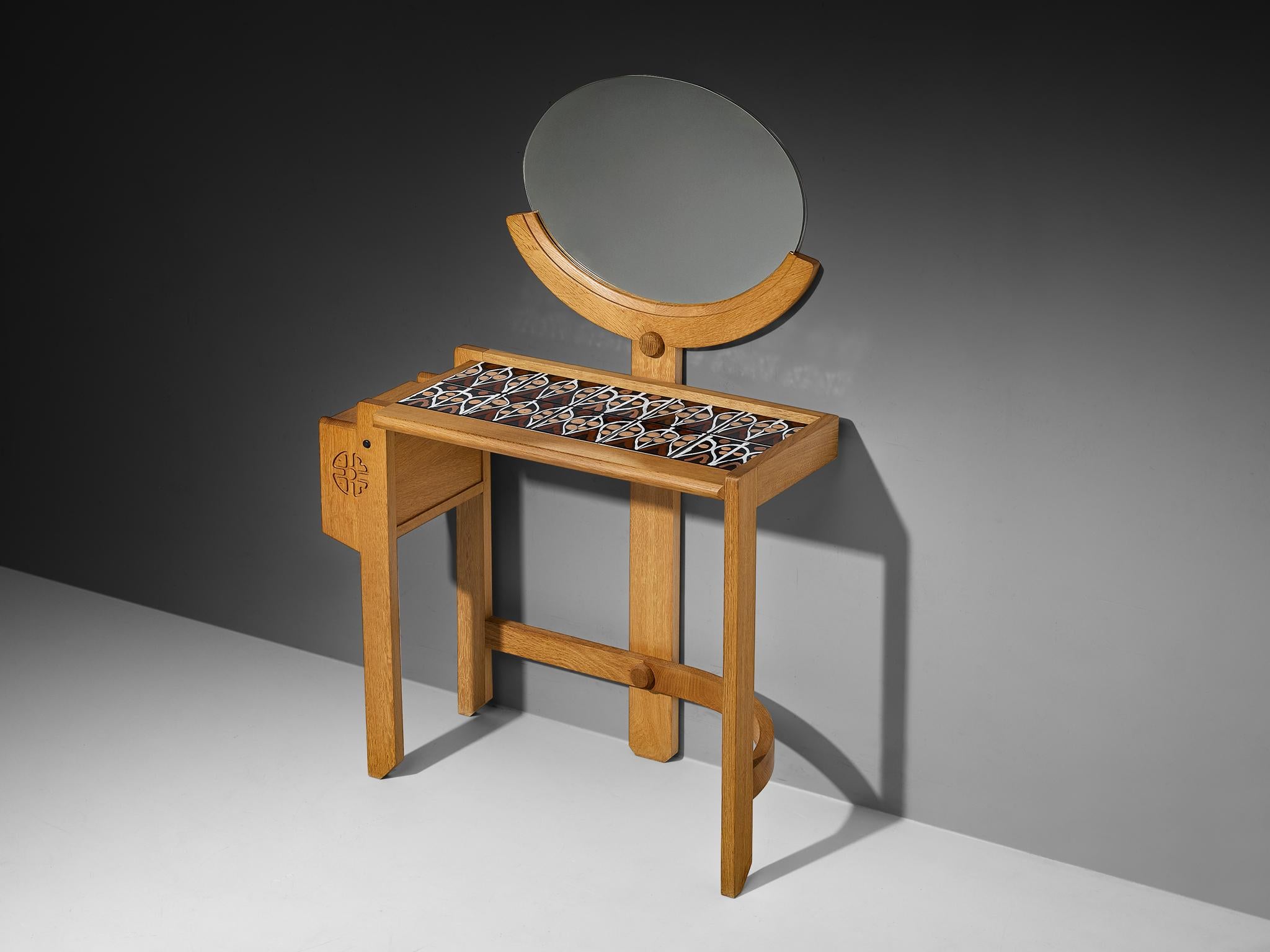 Guillerme et Chambron, vanity table, oak, ceramic, mirror, France, 1960s.

This dressing table is designed by the French designer duo Guillerme and Chambron. It features their characteristic design elements, such as the decorative ceramic tiles on