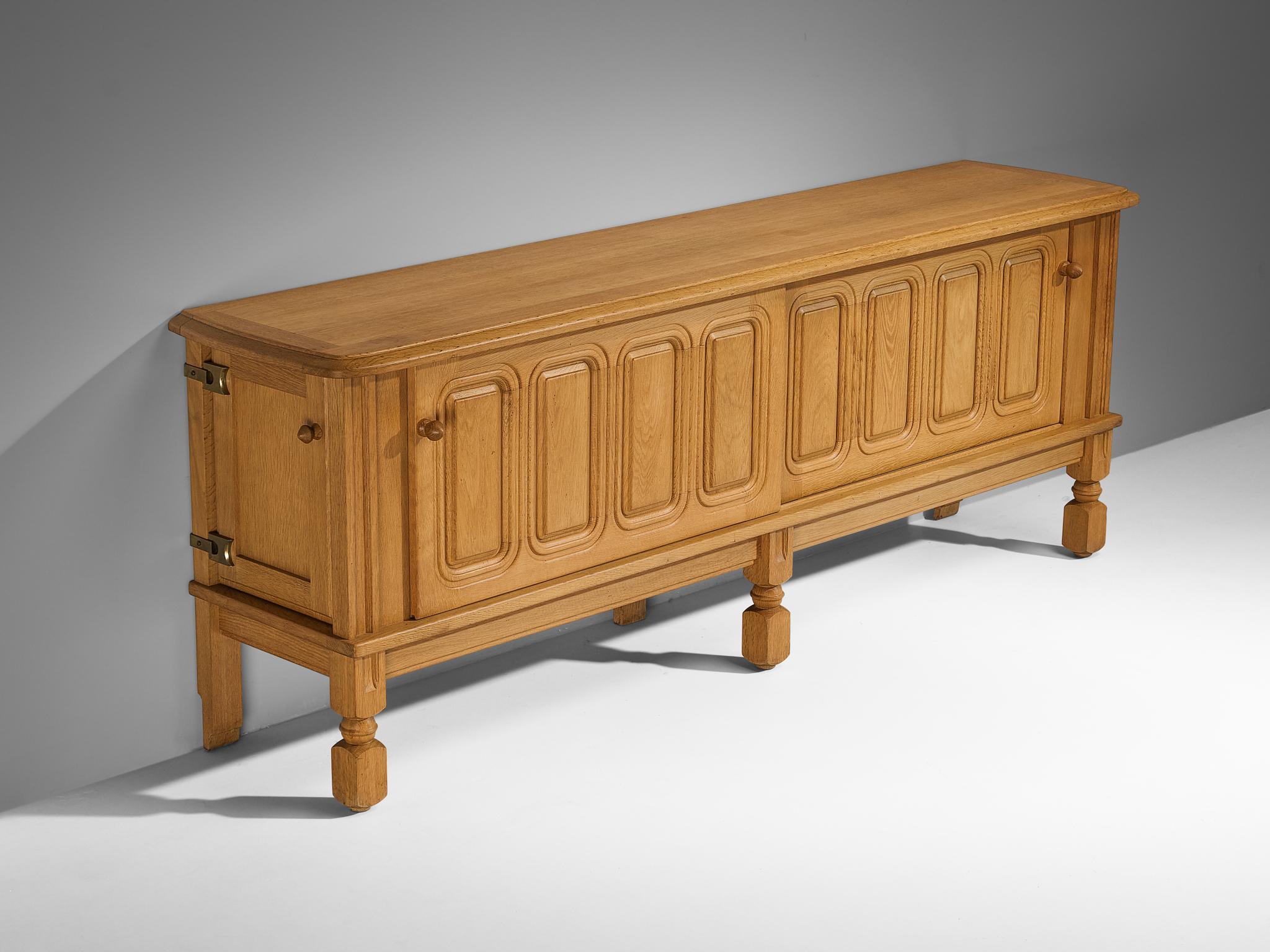 Guillerme et Chambron for Votre Maison, sideboard, oak, France, 1960s.

This charming sideboard is made by the designer duo Guillerme & Chambron. This particular design is characterized by a solid construction that is noticeable in the engraved