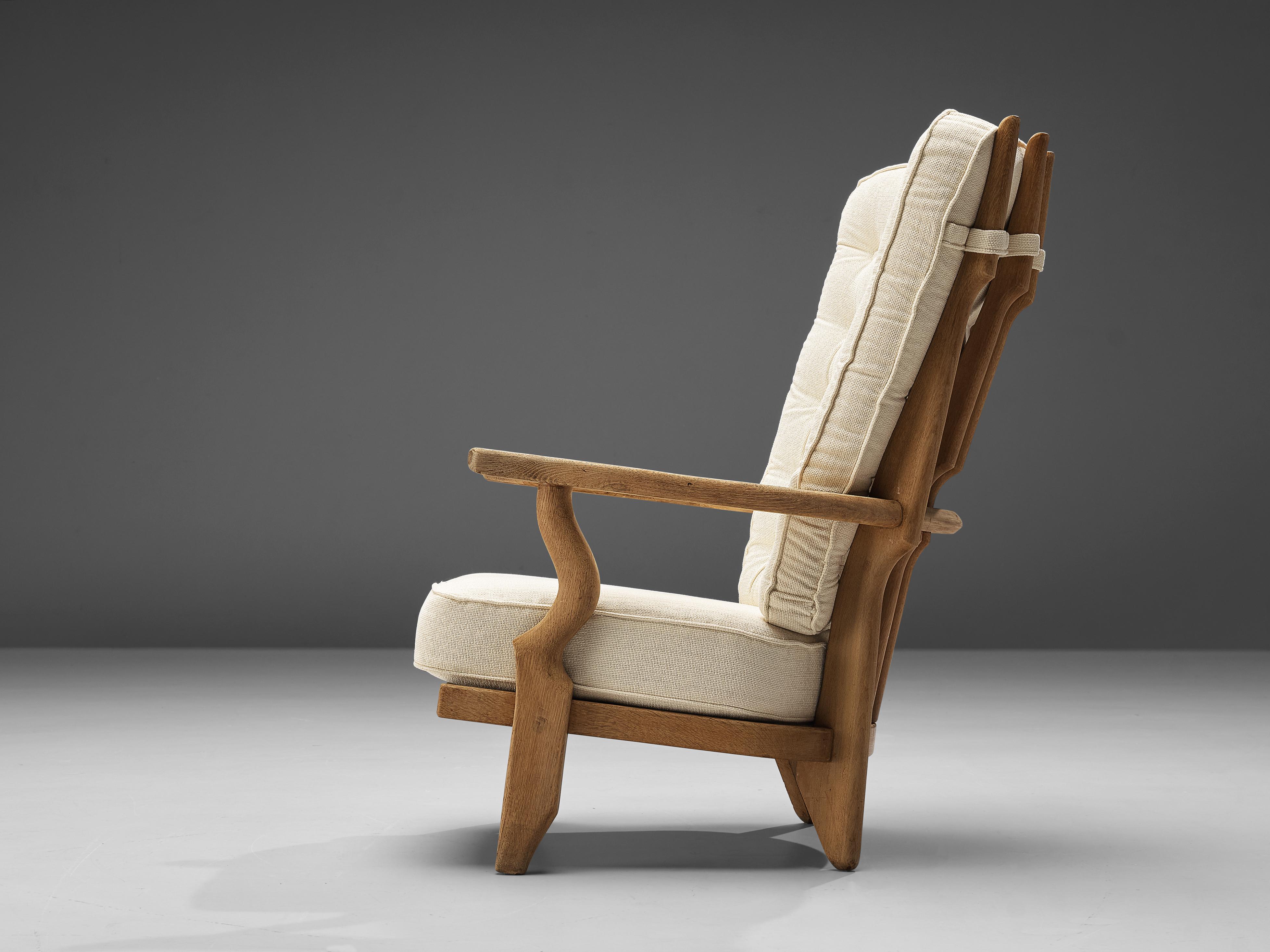 Guillerme & Chambron, 'Grand Repos' lounge chair oak, white fabric, oak, France, 1960s.

Guillerme & Chambron are known for their high quality solid oak furniture, from which this is another great example. This chair has an interesting, sculptural