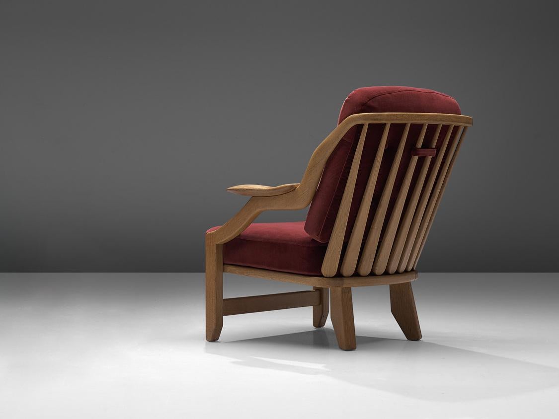 Guillerme et Chambron for Votre Maison, lounge chair, model 'Gregoire', burgundy red fabric, oak, France, 1960s

Comfortable lounge chair designed by Guillerme and Chambron. These chairs have a very interesting shape looking from the side. The