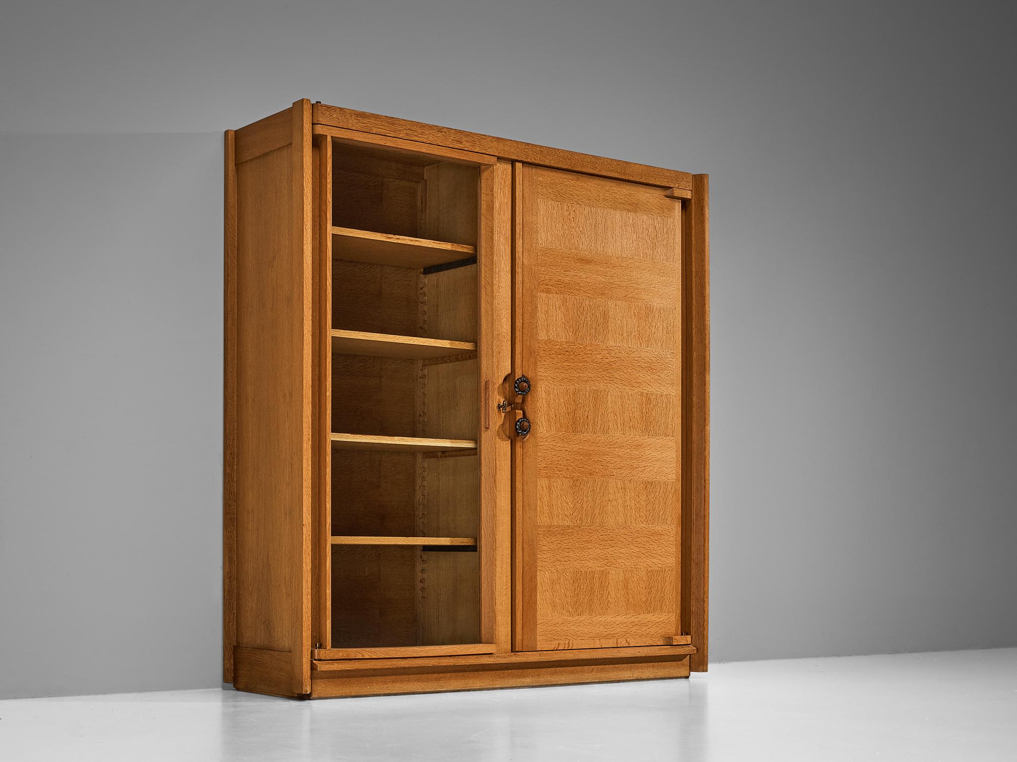 Guillerme et Chambron, highboard or cabinet, oak, glass, ceramic, France, 1960s

This wardrobe is based on a well-designed structure where aesthetics and functionally go hand in hand. The door panels have the characteristics of the French designer