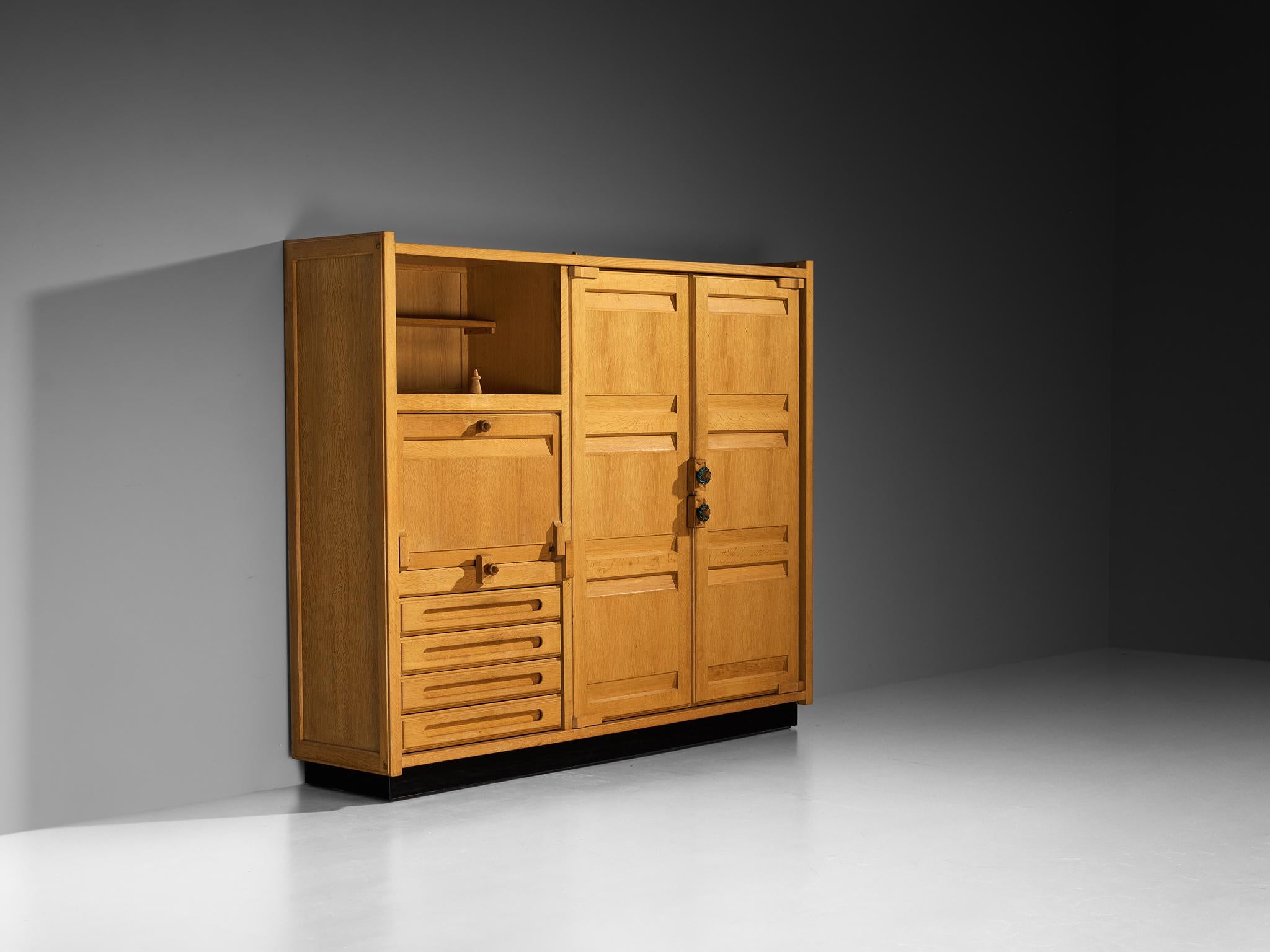 Guillerme et Chambron for Votre Maison, large sideboard or armoire, solid oak, ceramic, France, 1960s

This exceptional wardrobe designed by the French duo Guillerme et Chambron exemplifies their dedication to craftsmanship, simplicity in form,