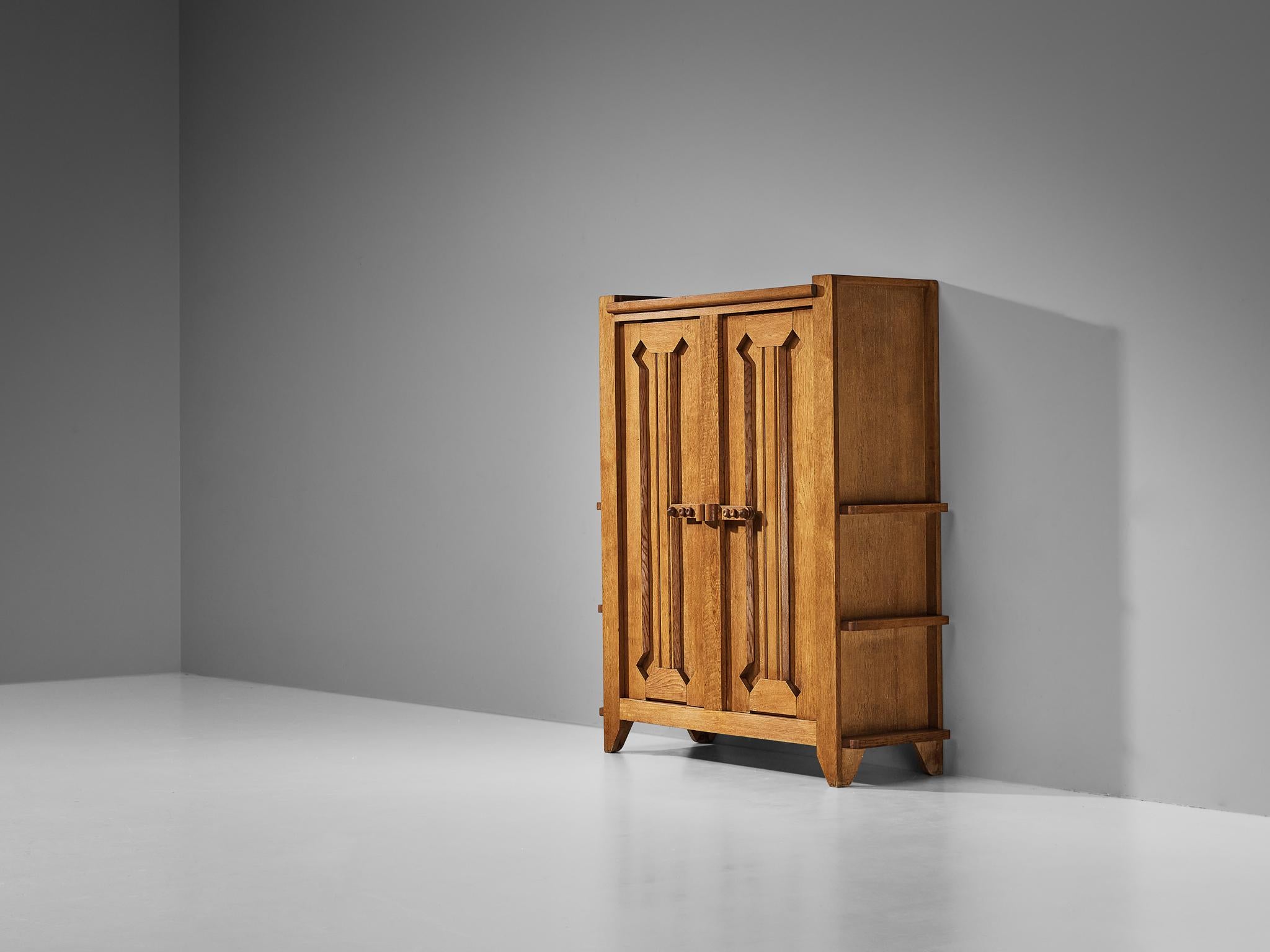 Guillerme et Chambron for Votre Maison, wardrobe, solid oak, metal, France, 1960s

This wardrobe is based on a well-designed structure where aesthetics and functionally go hand in hand. The door panels have the characteristics of the French designer