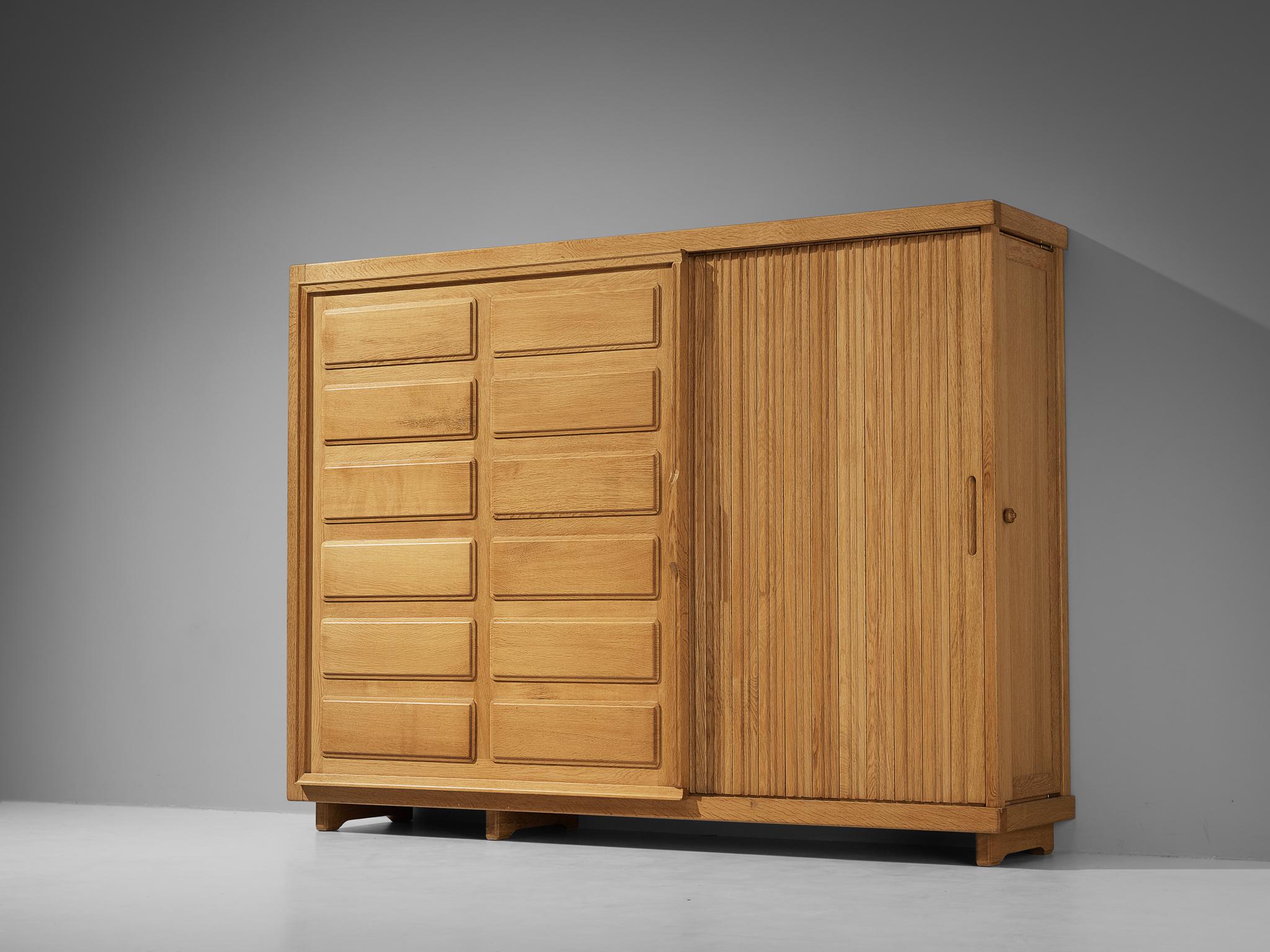 Guillerme et Chambron for Votre Maison, armoire or large cabinet, oak, France, 1960s

This grandiose highboard or wardrobe is a good example of excellent woodworking by virtue of the graphical designed door panels illustrating elongated, vertical