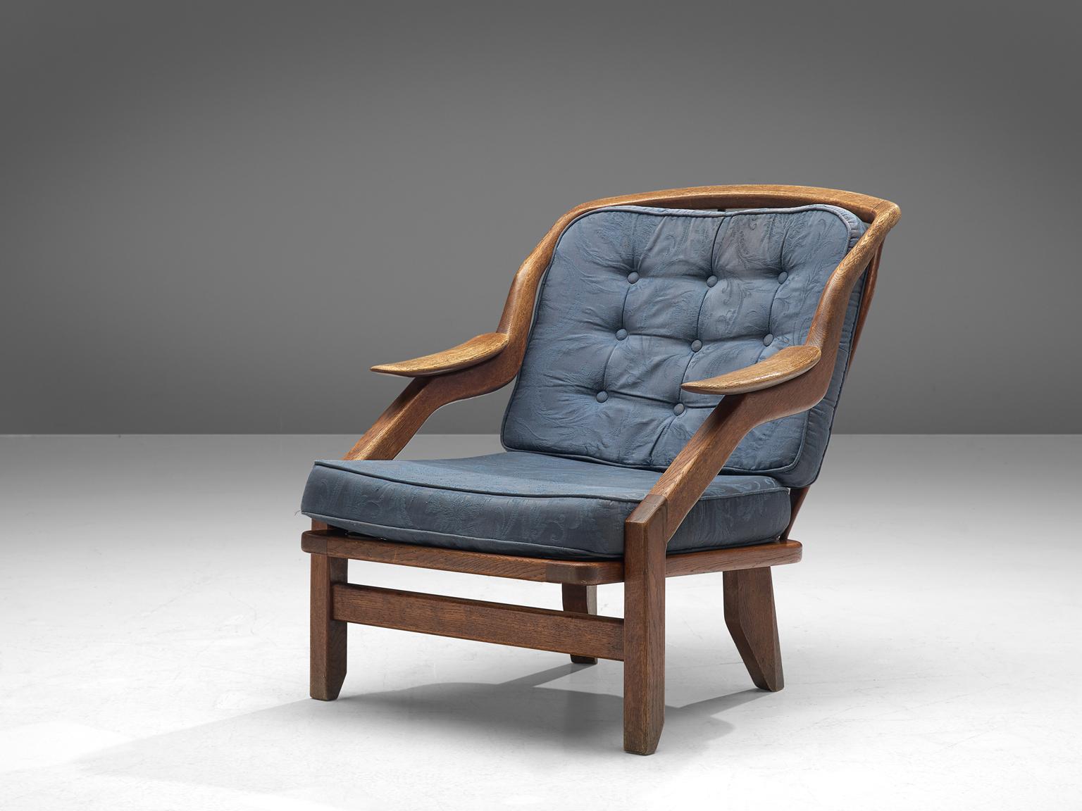 Guillerme and Chambron, lounge chair, blue fabric and oak, France, 1950s. 

This French designer duo is known for their extreme high quality solid oak furniture, from which this lounge chair is another great example. The chair has a very