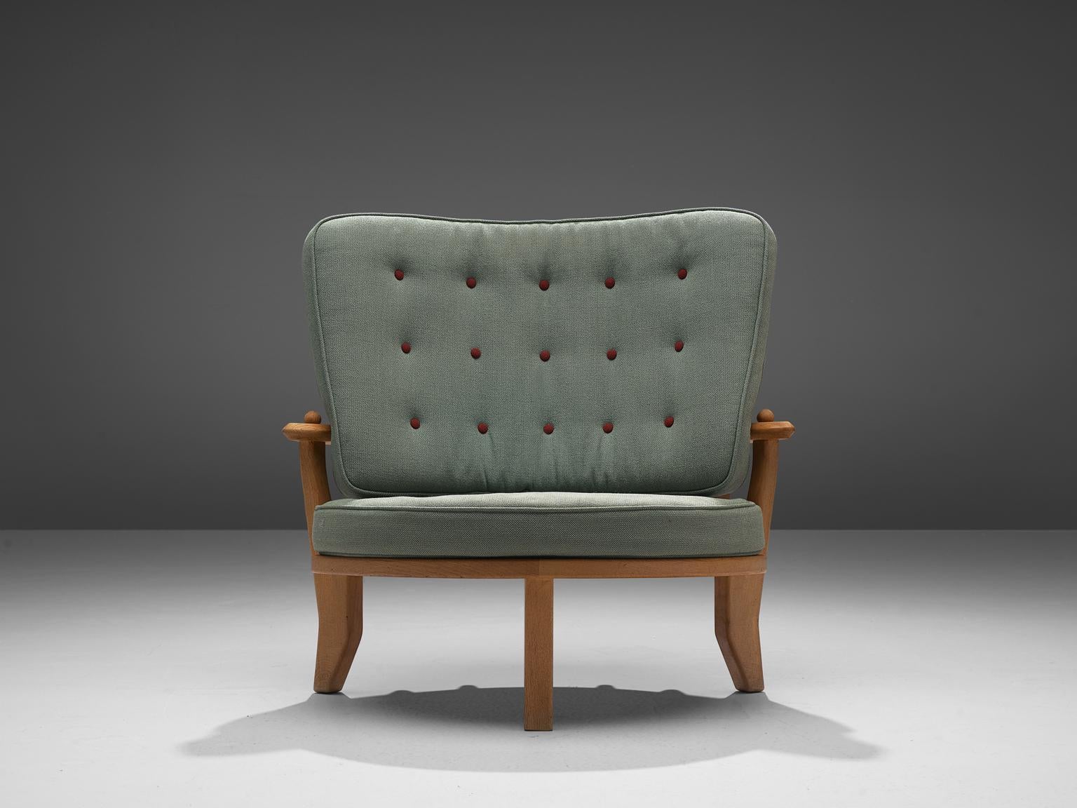 Guillerme et Chambron, lounge chair, oak, green upholstery, France, 1940s. 

This lounge chair or love chair has a classic Guillerme & Chambron style. It is bulky but beautifully made, with attention to detail and comfort. Guillerme and Chambron
